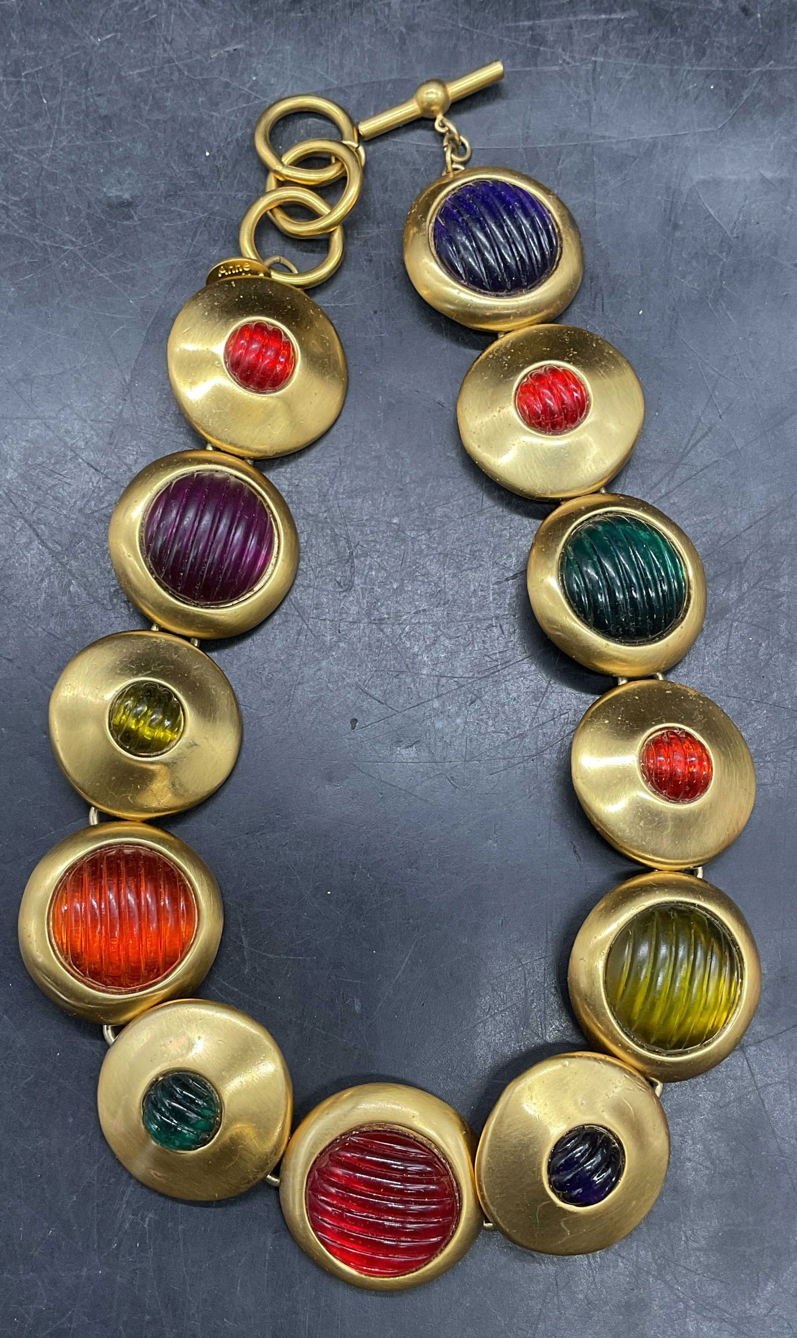 Vintage Anne Klein Couture Gold Tn Necklace: Vintage signed Anne Klein Couture gold tone disc necklace with lucite cabochons. Drop length approx 6.25 inches. Some scratching. Property of Upper East Side French stage and screen actors estate,