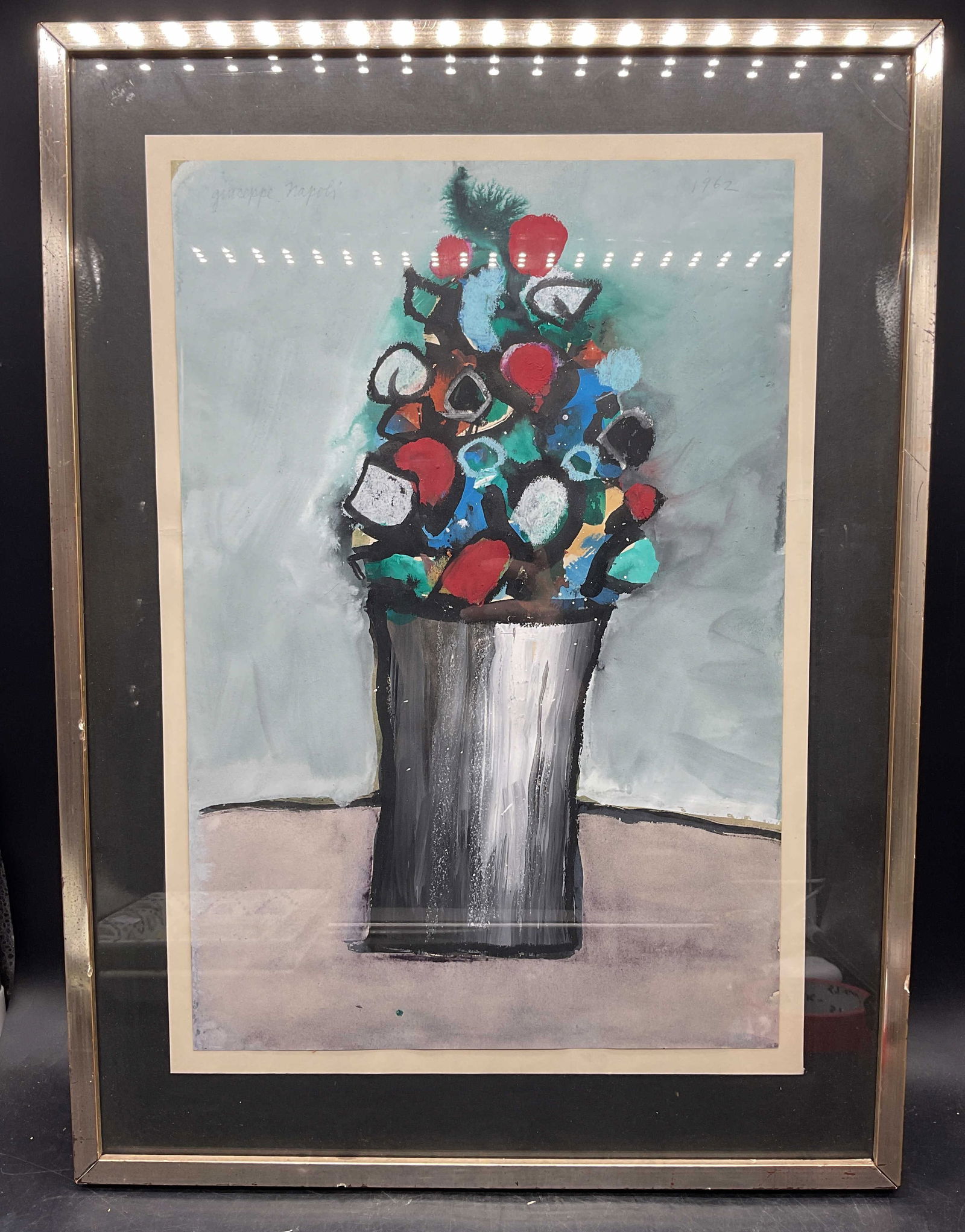 Giuseppe Napoli Still Life Flowers Painting: Framed painting on paper. Mixed media. Signed upper left, Giuseppe Napoli (American, 1929-1967), dated 1962. Abstract still life with flowers. Silver leaf wood frame. Not examined out of frame.