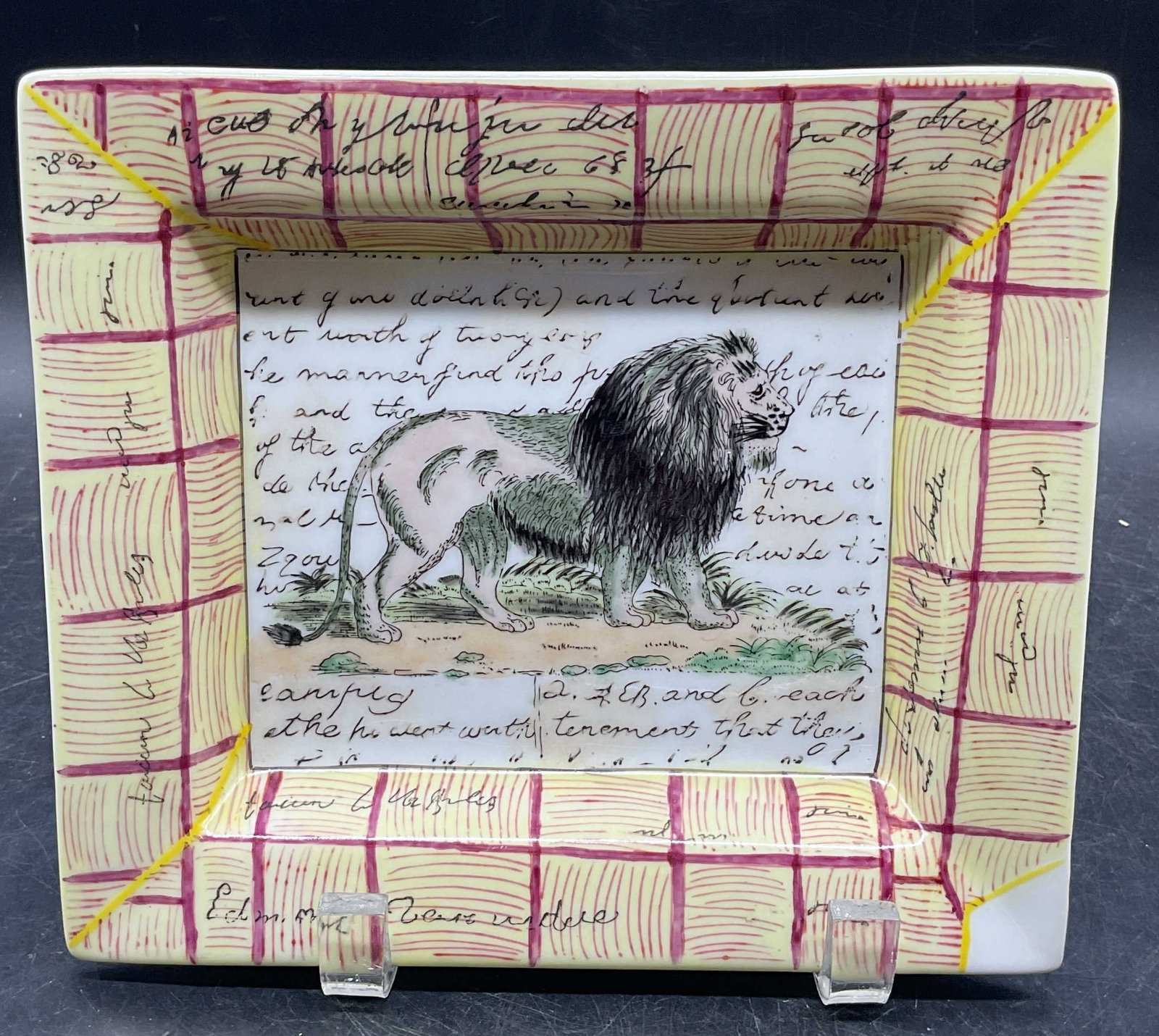 John DERIAN Hand Painted Porcelain Lion Plate: Signed John DERIAN for Tozai Home hand painted porcelain rectangular plate with Lion motif. Measures approx. 7.75 x 6.75 inches. Plate has weight. Some scratching. John DERIAN plate, porcelain plate, 