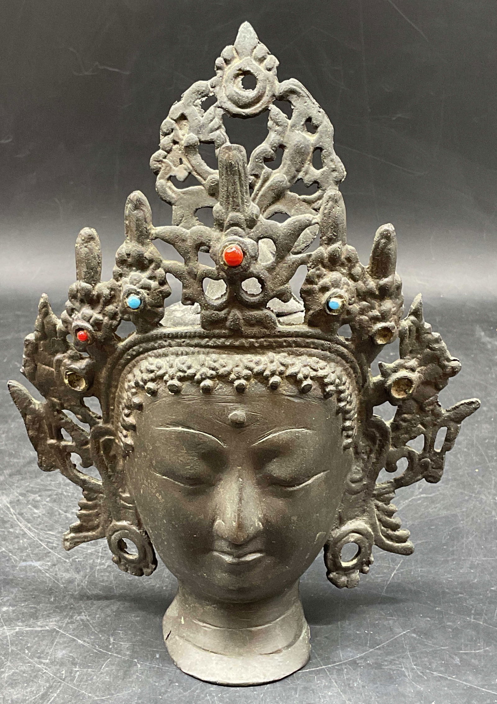 Indian Bronze Head of Goddess Tara Figural: Indian bronze depicting the goddess Tara. Faux turquoise and coral enamel. Measures approx. 6.5 x 2.5 x 8 inches. Wear including patina and loss to enamel. Bronze head, Indian bronze, collectibles, ho