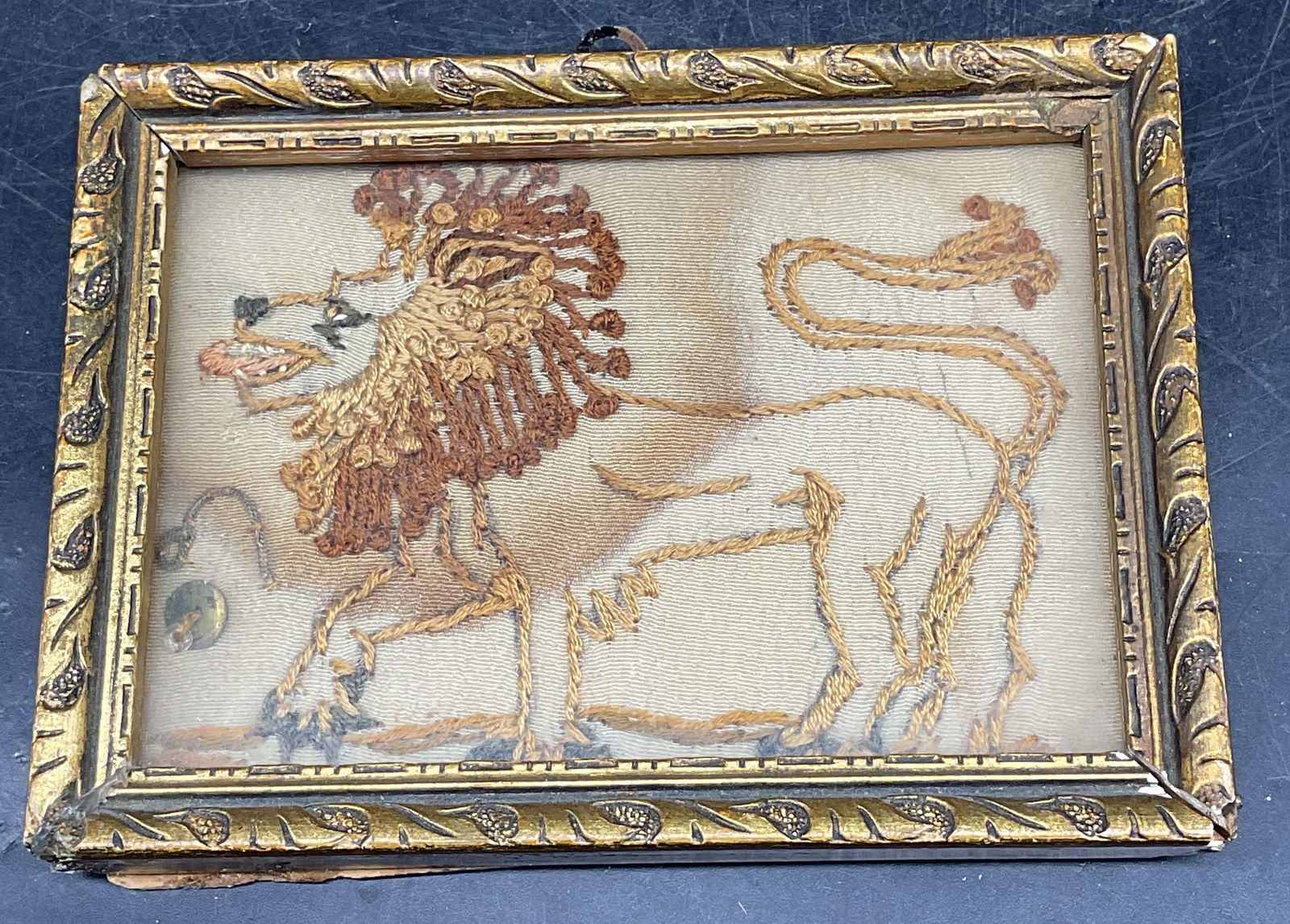 Vintage Framed Lion Embroidered Panel: Vintage, possibly antique, embroidered textile panel depicting a lion. Gilt wood frame. Not examined out of frame. Frame measures approx. 3.25 x 4.5 inches. Wear including discoloration. Art, textile