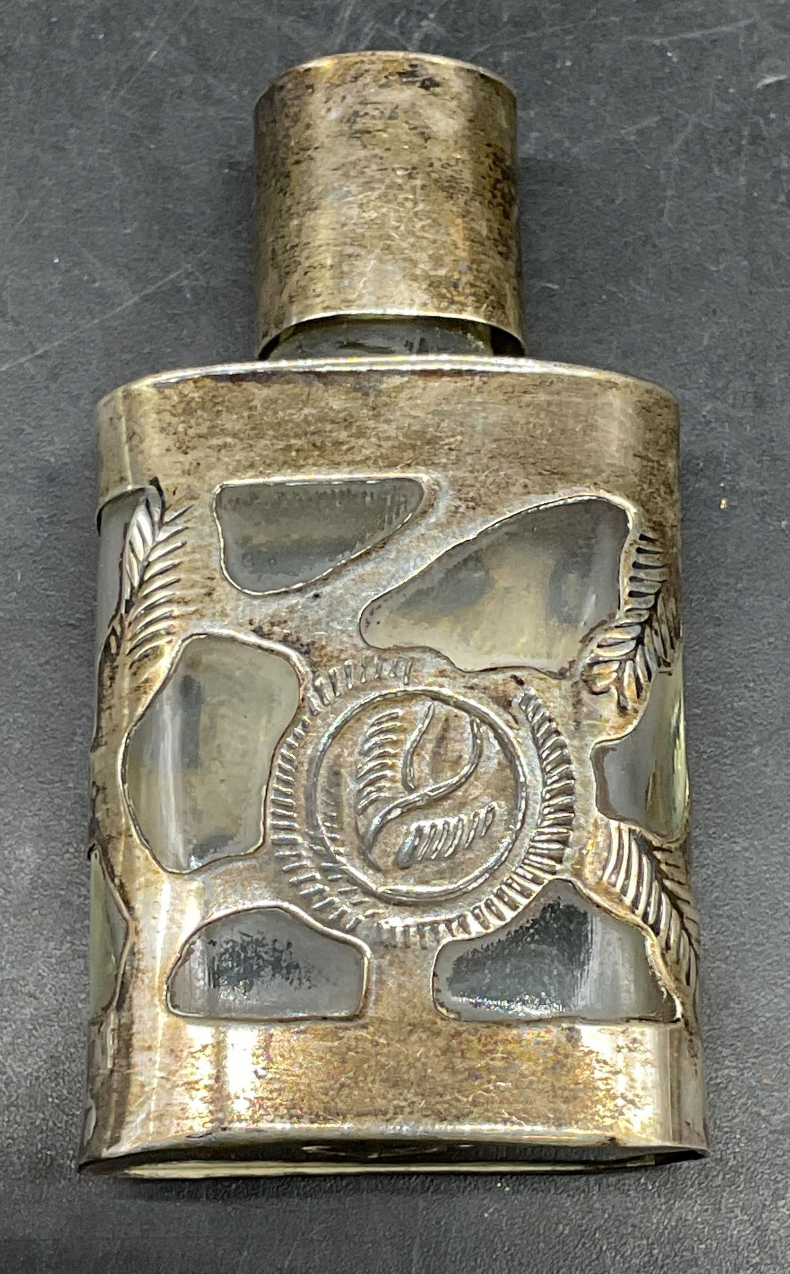 Vtg Sterling Silver Glass Perfume Bottle, Mexico: Vintage glass perfume bottle with sterling silver overlay. Signed illegibly. Made in Mexico. Marked sterling. Total weight 22.1 grams. Measures approx. 1.25 x .5 x 2 1/8 inches. Wear including patina