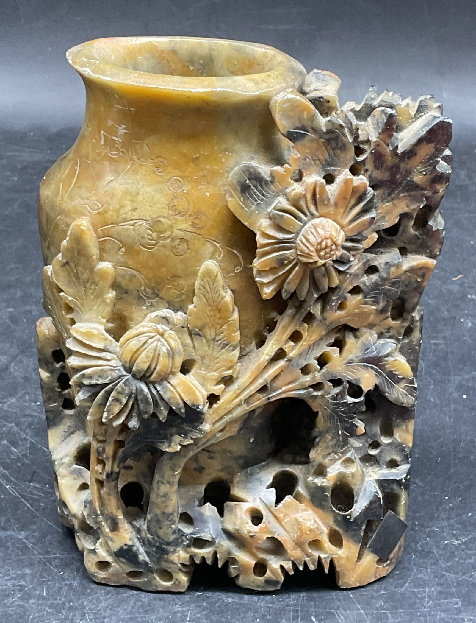 Carved Floral Soapstone Vase Brush Pot: Asian carved soapstone vase or brush pot with raised floral design. Measures approx. 4.25 x 2 x 6 inches. Some wear including scratching and small chips. Soapstone vase, soapstone brush pot, Asian