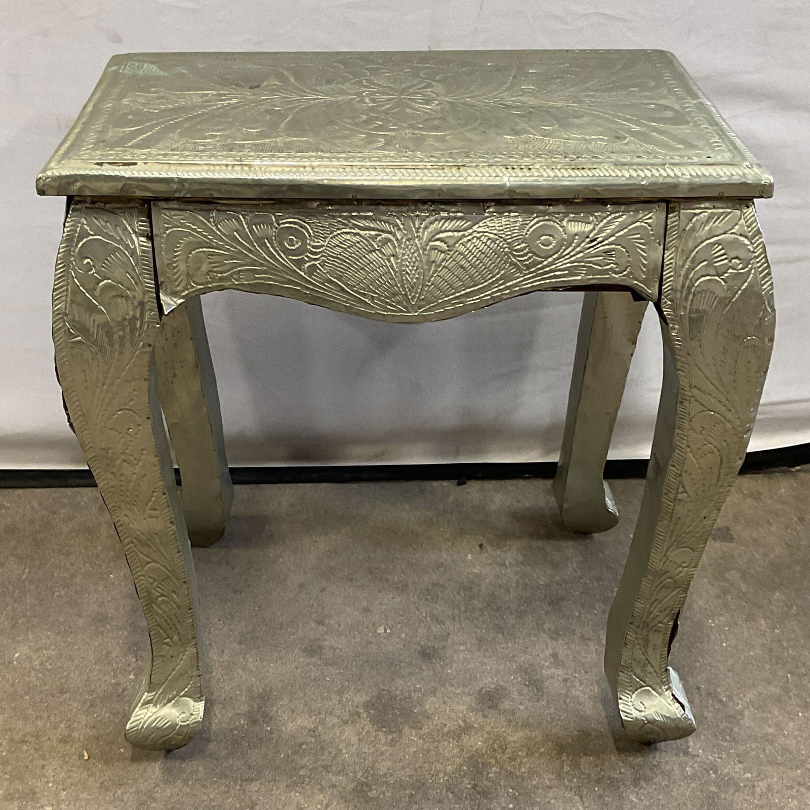 Anglo Indian Repousse Silver Tn Wood Side Table: Vintage, possibly antique Anglo Indian style side table with drawer. Hand hammered repousse silver tone metal over wood. Ornate floral scroll design. Measures approx. 18 x 13 x 18.5 inches. wear