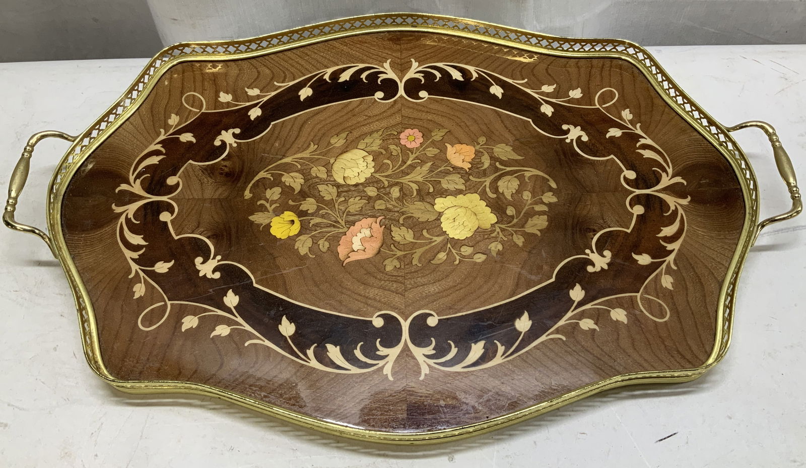 Vtg Ercolano Floral Inlay Serving Tray ITALY 20in: Vintage serving tray features intricate floral inlay & a brass openwork border with handles. Shades of pink, yellow & brown. Signed & marked on underside. Reads, MADE IN ITALY. ERCOLANO. Surface