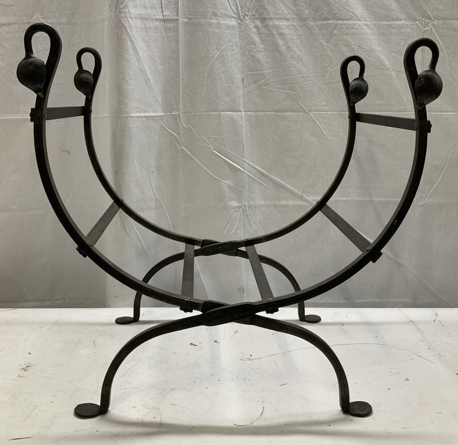 Vtg Wrought Iron Fireplace Log Holder: Vintage wrought iron fireplace log holder, features a distinctive u shaped & leaf accents on 4 corners. Log holder has weight. Surface wear consistent to age, use & exposure. Measurements: length 23.2