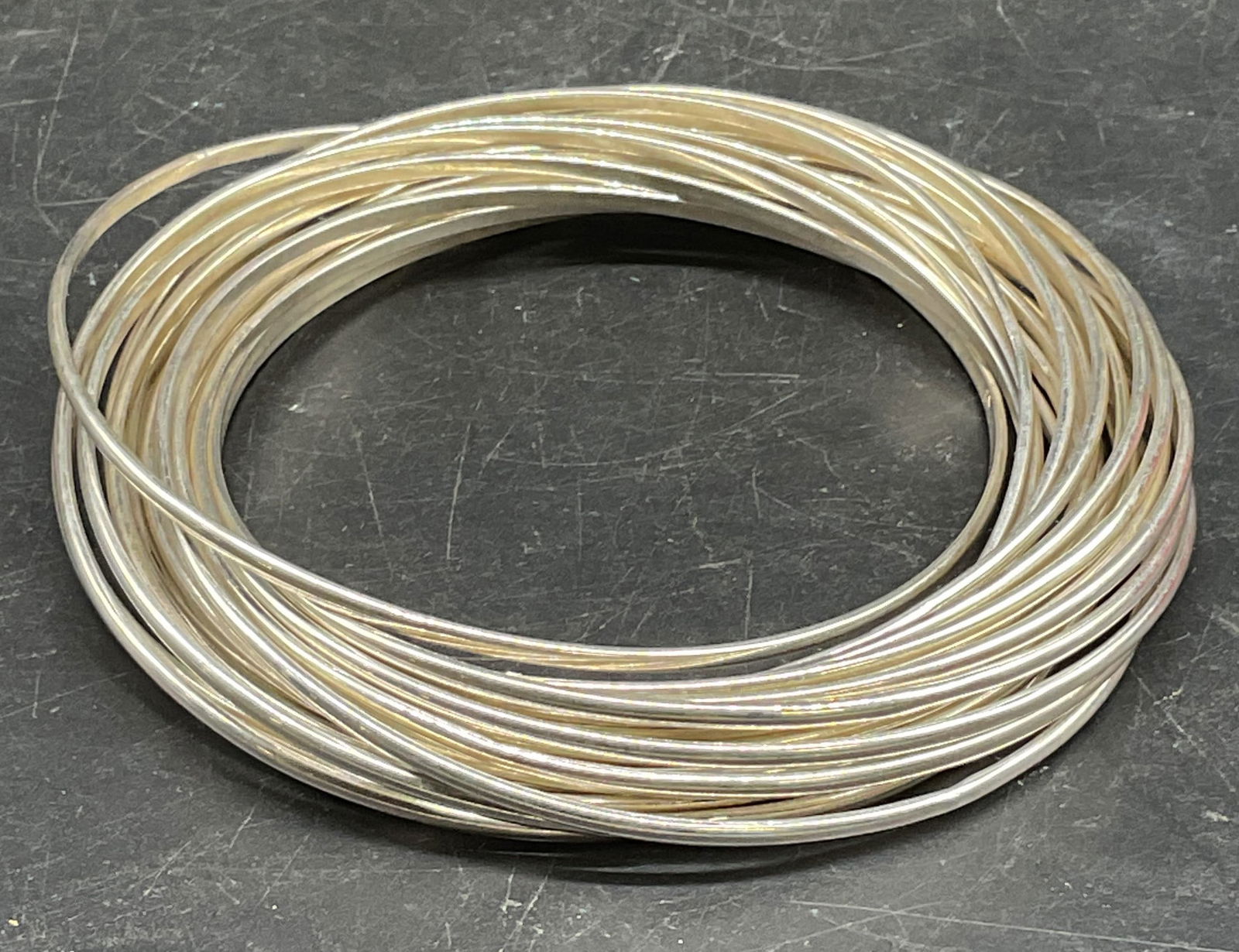 Sgn Sterling Silver Interlocking Bangle Bracelet: Signed Sterling silver multi band interlocking bangle bracelet. Marked sterling. Signed illegibly. Measures approx. 2.5 inches wide. Total weight 85.9 grams. Some scratching. Jewelry, estate