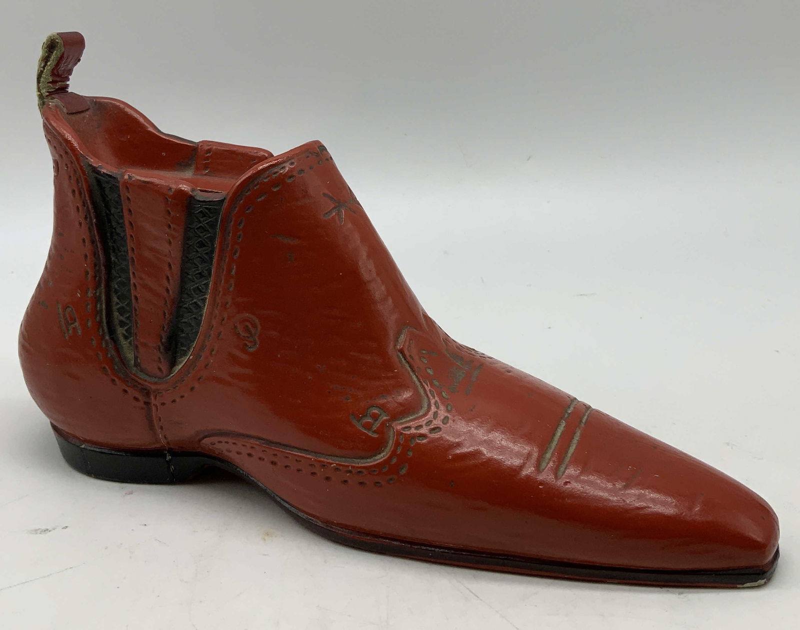 Vtg Lego Red Cowboy Boot Coin Bank: Vintage western style cowboy boot coin bank. Features stitching details & coin slot at top. Access point on bottom. Red toned. Signed & marked on underside. Reads, LEGO. Surface wear consistent to age