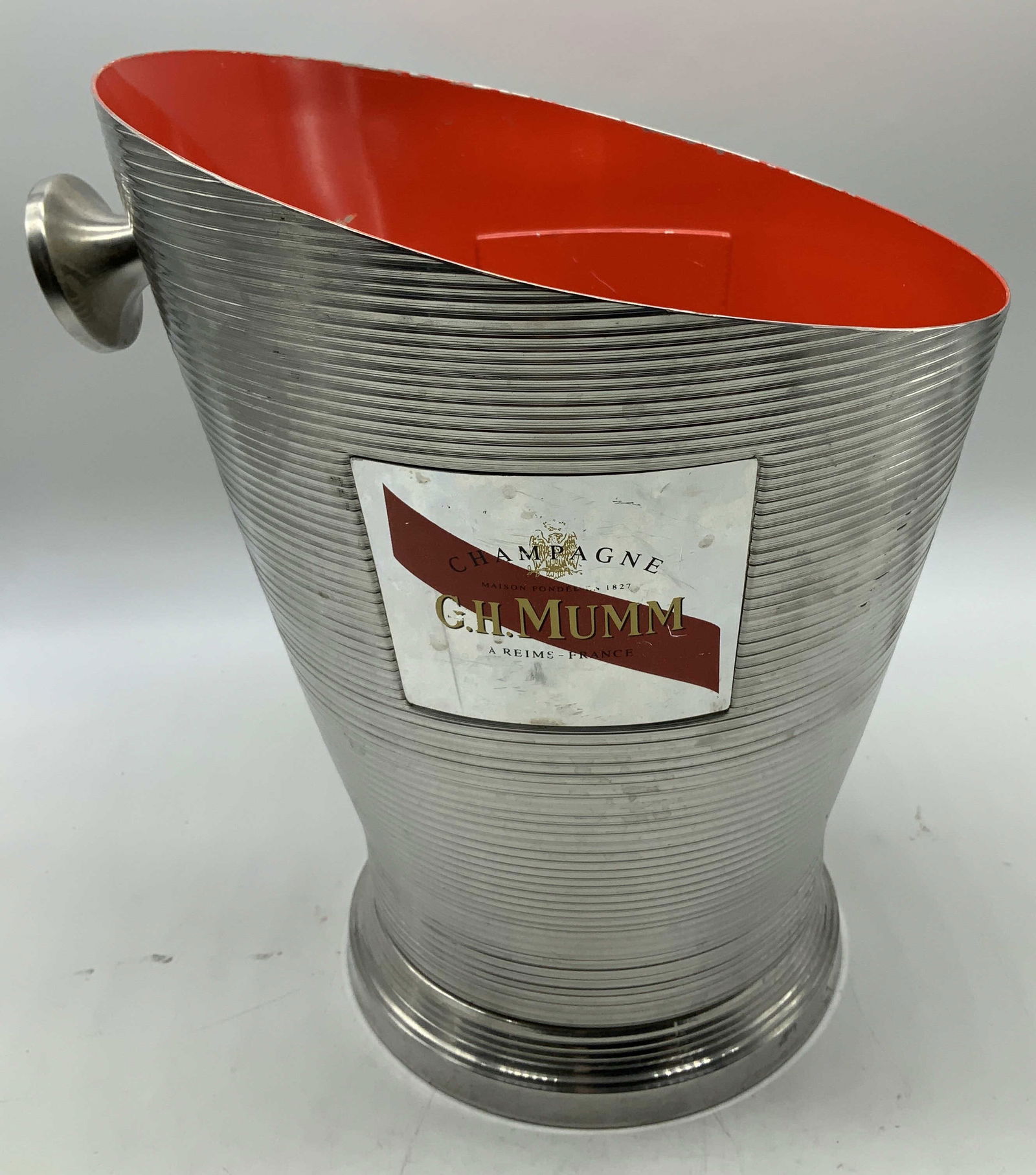 Vtg G.H. Mumm Champagne Cooler FRANCE: Vintage G.H. Mumm champagne cooler features a ribbed exterior design & red toned interior. Asymmetrical shape. Appears to be aluminum material. Surface wear consistent to age, use & exposure.