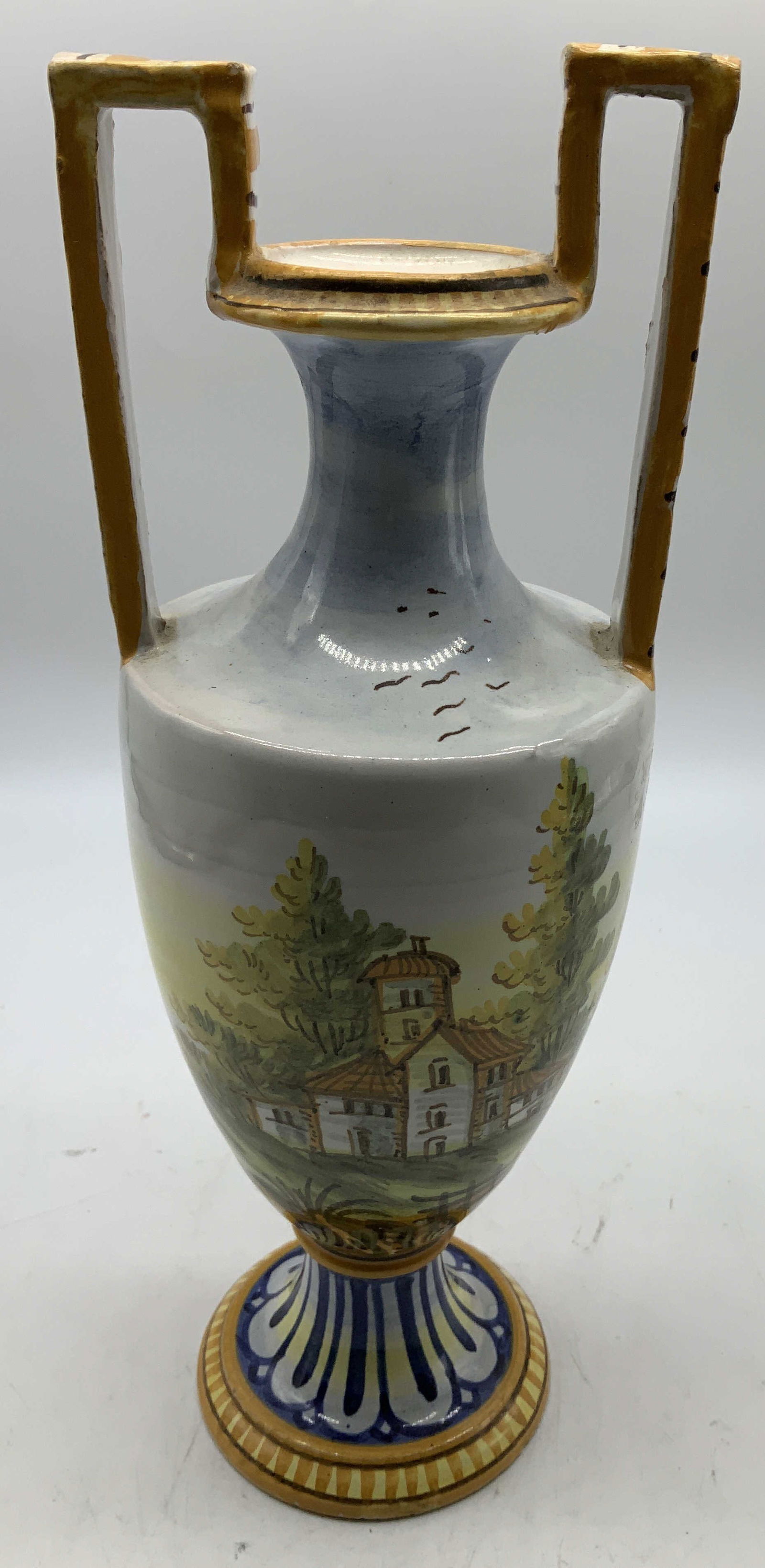 Vtg Hand Painted Landscape Quimper Vase: Vintage Quimper vase features a hand painted landscape scene. Shades of orange, blue, yellow, green. Baluster shape & square handles. Surface wear consistent to age, use & exposure. Measurements: leng