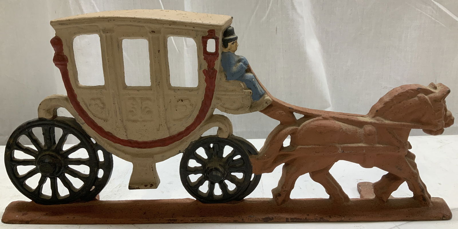 Vtg Cast Iron Horse Carriage Doorstop: Vintage cast iron doorstop depicting a horse pulling a carriage with a driver. Shades of blue, red, black. Surface wear consistent to age, use & exposure. Signed & marked on underside. Reads, C.N. Mea