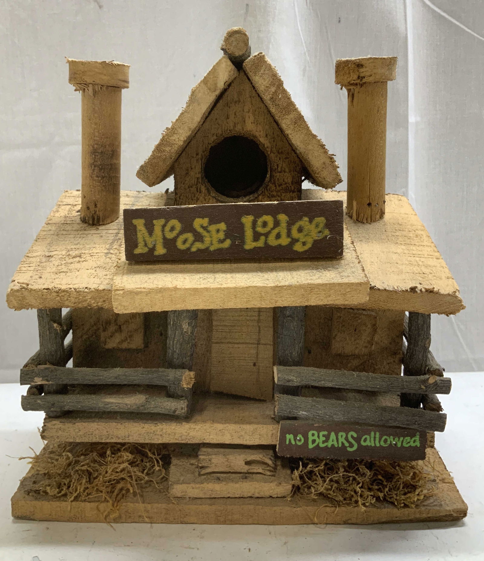 Moose Lodge Wooden Birdhouse 9.5in: Moose lodge folk art birdhouse features miniature logs, a front porch & small wooden signs that read, Moose Lodge & No Bears Allowed. Brown toned. Surface wear consistent to age, use & exposure. Measu