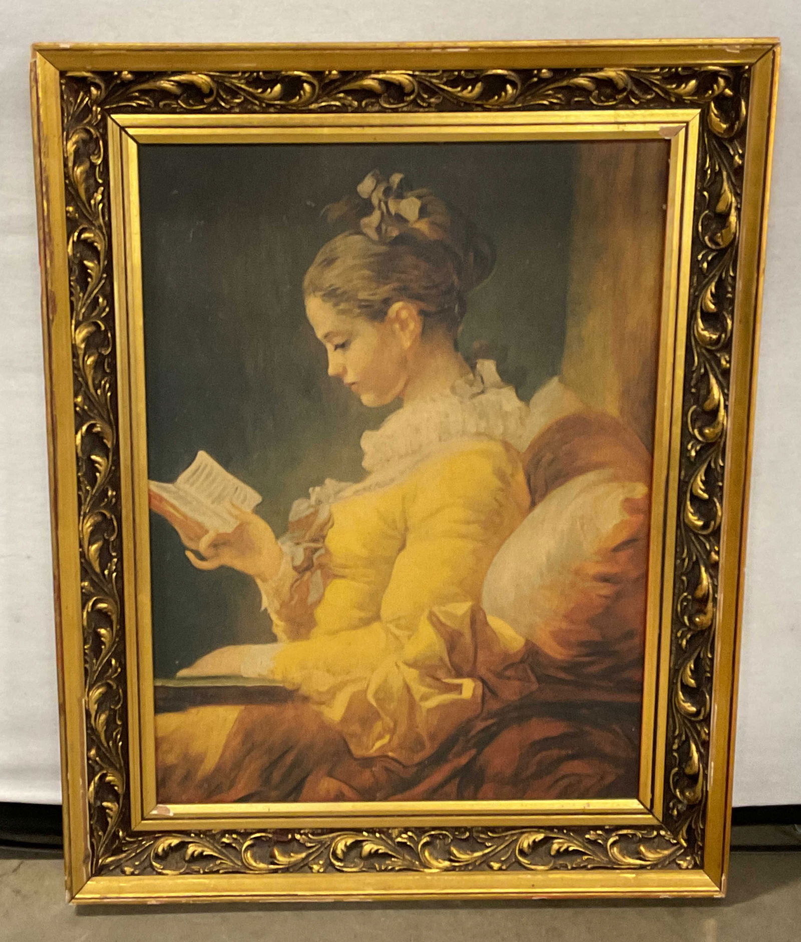 Framed Woman Reading Oil Painting 29.5in: Framed oil on canvas painting. Seated woman reading a book. Ornate gilt wood frame. Not examined out of frame. Frame measures approx. 29.5 x 23.5 inches. Wear including chips and losses to frame. Some