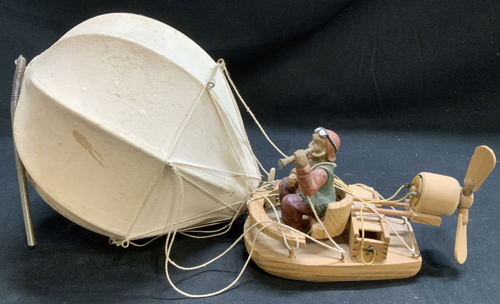 Vntg Model Hot Air Ballon W Propeller Motor: Vintage hot air balloon featuring a seated pilot figure wearing a helmet & goggles. Gondola supports a motor that is battery operated. Strings are attached to a fabric balloon. Has not been tested for
