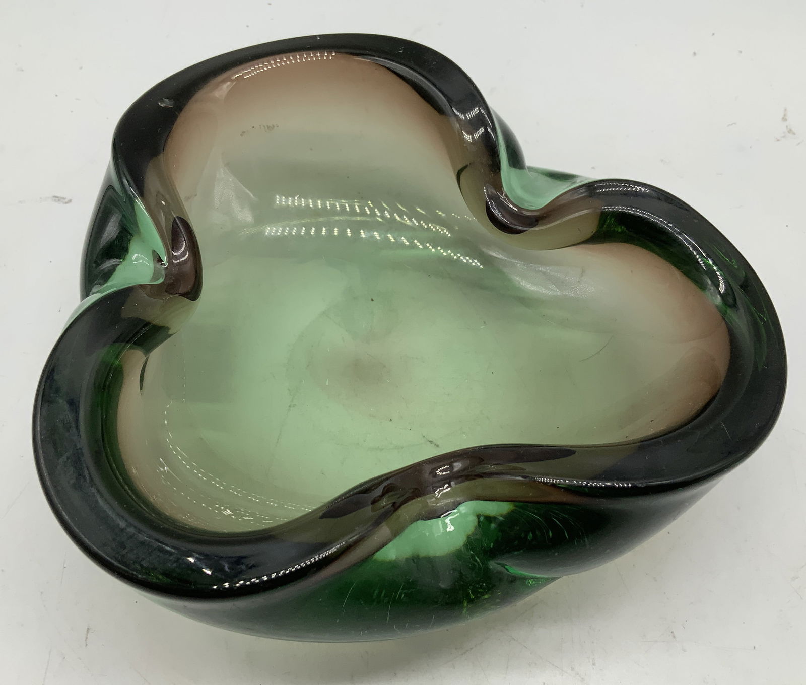 Vtg Murano Style Green Art Glass Bowl: Vintage Murano style bowl features thick glass & a three lobed shape. Green toned. No visible signature or markings. Surface wear consistent to age, use & exposure. Measurements: length 7in x width 7i