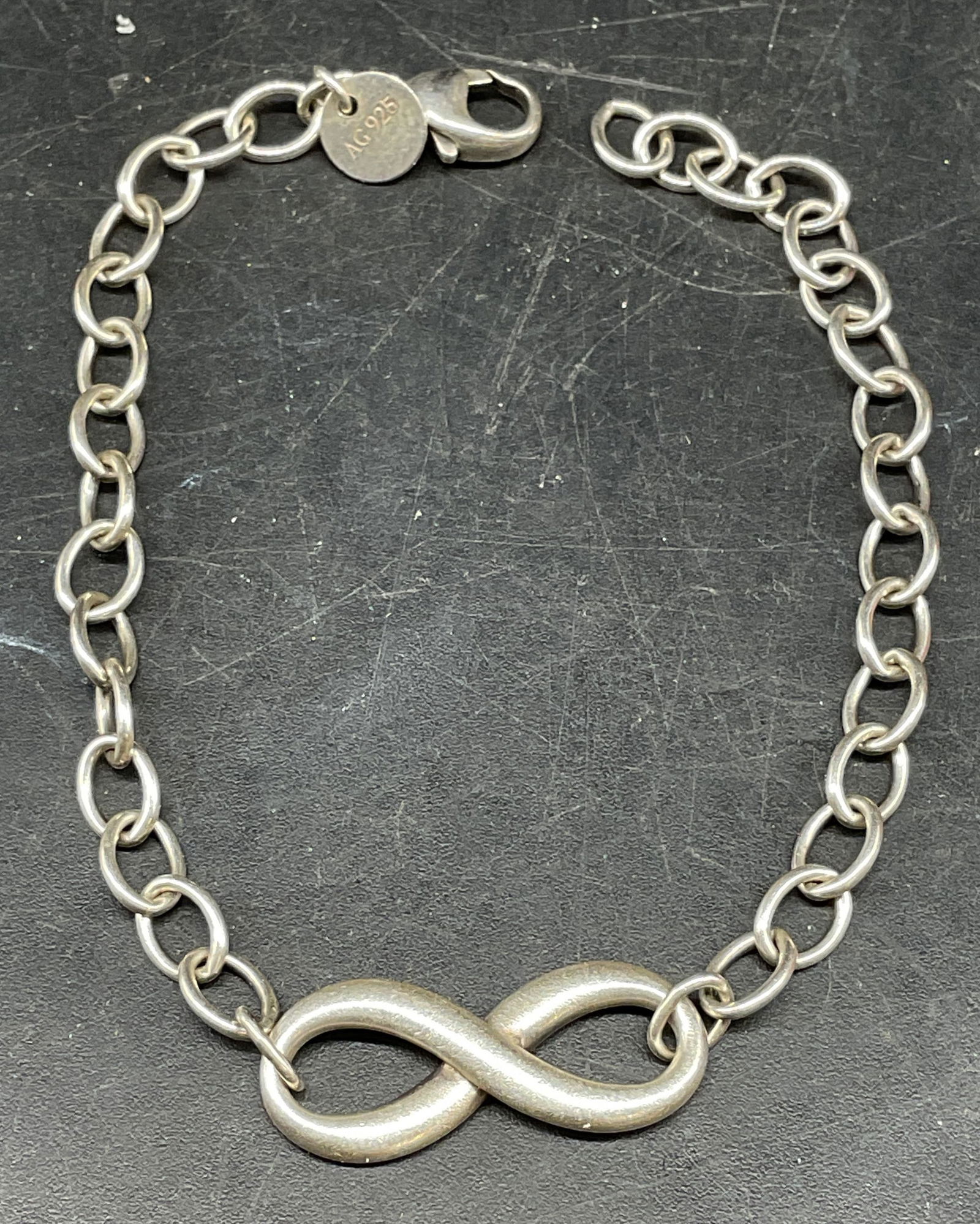 Tiffany & Co Sterling Silver Infinity Bracelet: Signed Tiffany & Co Sterling silver infinity bracelet. Measures approx. 6.75 inches long. Marked sterling. Total weight 6 grams. Some scratching. Jewelry, estate jewelry, fine jewelry, cocktail jewelr