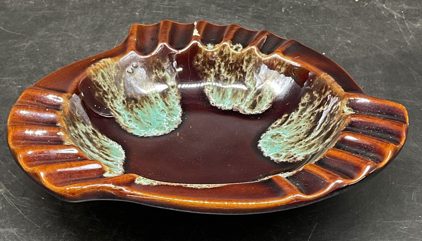MCM Art Pottery Blue Brown Ashtray USA: Vintage mid century modern art pottery ashtray in blue and brown drip glaze. Made in USA. Numbered 3505. Measures approx. 7.75 x 1.75 inches. Wear including crazing, hairlines, and small chips. Art po