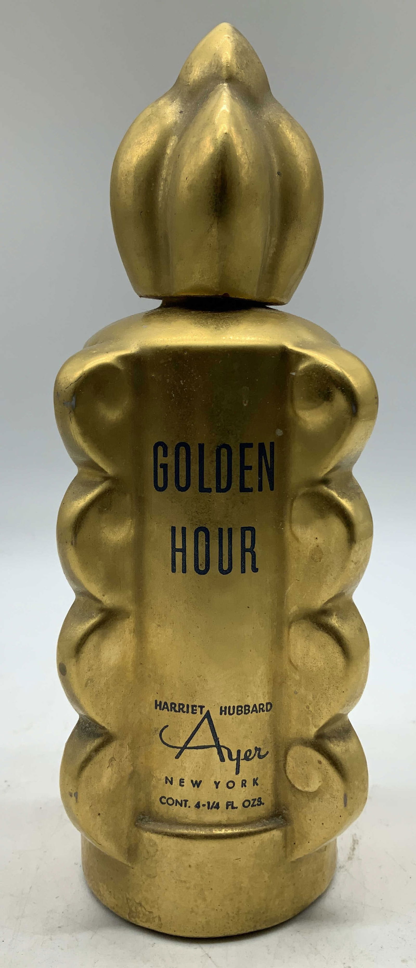 Vtg Harriet Hubbard Ayer Golden Hour Perfume Bttle: Vintage Golden Hour perfume bottle by Harriet Hubbard Ayer. Features a distinctive textured, scalloped edge body. Gilt toned. Ceramic material. Signed & marked. Reads, HARRIET HUBBARD AYER NEW YORK. S