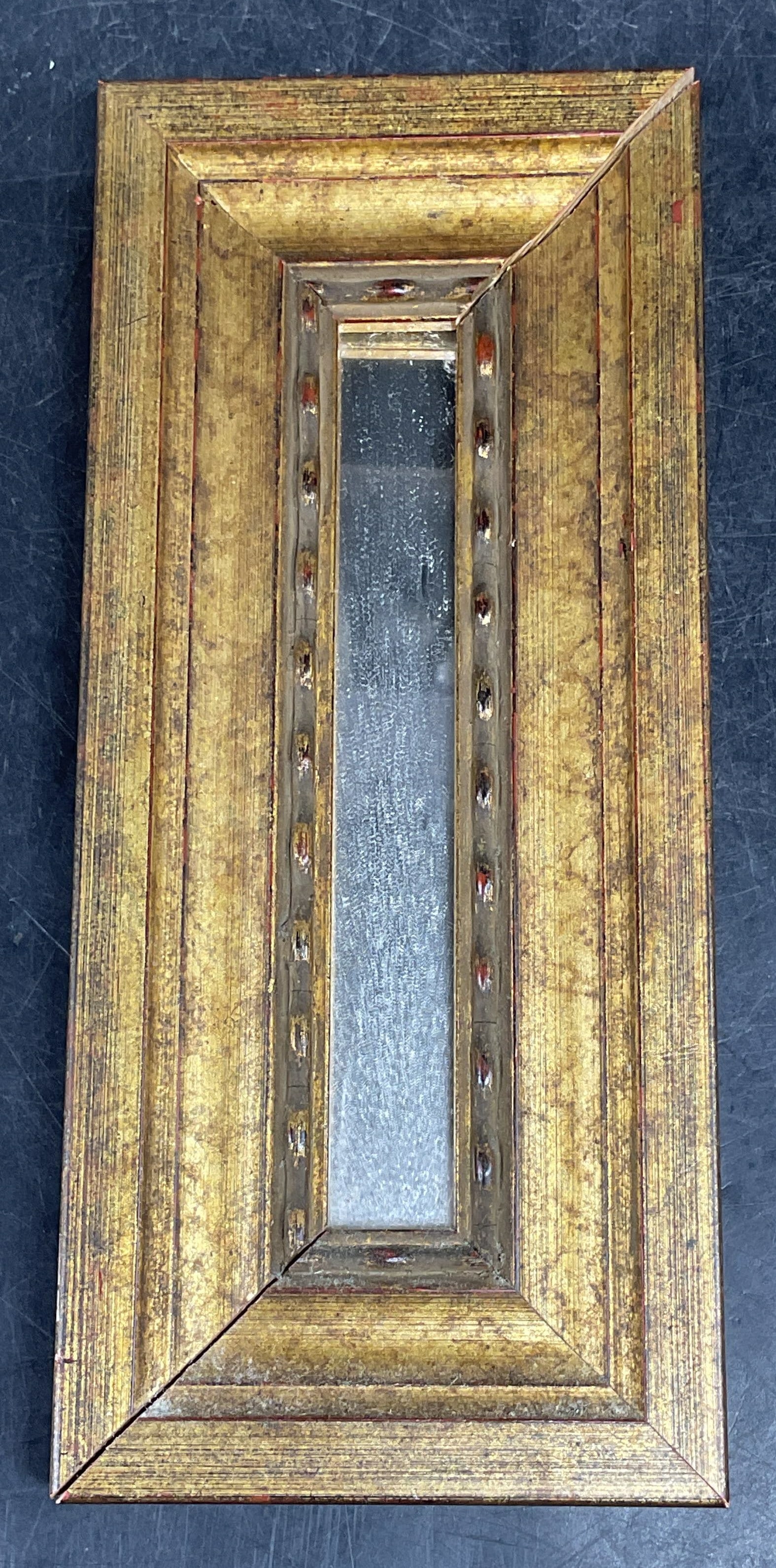 Gilt Wood Neoclassical Style Wall Mirror: Vintage gilt wood neoclassical style wall mirror with bead pattern. Measures approx. 8.5 x 3.75 inches. One corner loose, some scratching and loss to gilt. Mirror, wall mirror, gilt mirror, neoclassic