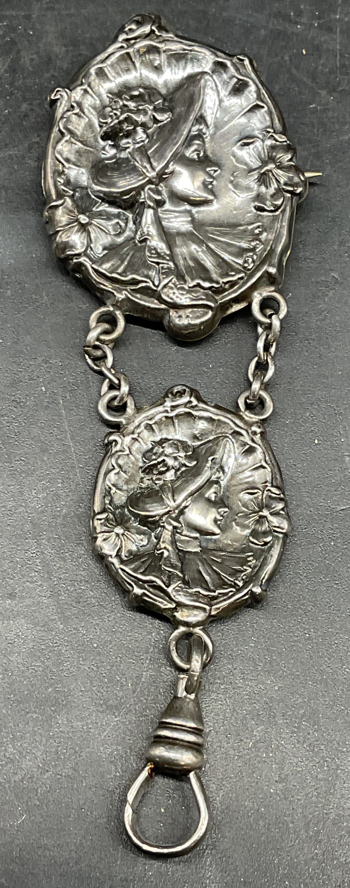 Antq Sterling Silver Woman Chatelain Fob Brooch: Antique art nouveau style sterling silver chatelain fob/brooch. Repousse woman cameo motif medallions. Marked sterling front. Measures approx. 3 x 1 inches. Total weight 5.7 grams. Some