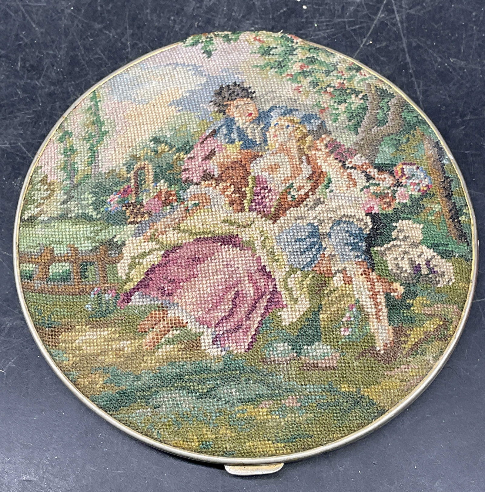 Vtg Bliss Brothers Petit Point Couple Compact: Vintage Bliss Brothers Co powder compact with mirror and compartment for powder. Petit point cover with courting couple motif. Green enamel on back cover. Measures approx. 3.5 inches wide. Wear