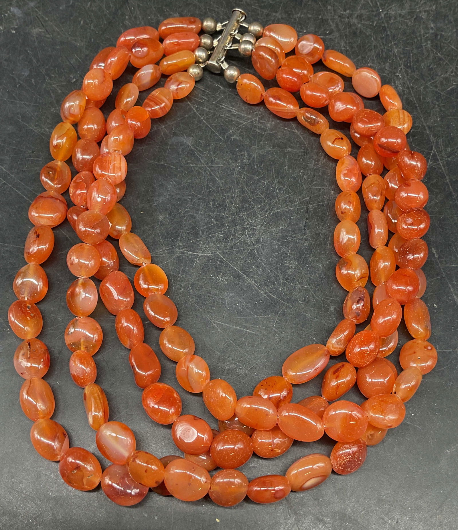 Vintage Carnelian Beaded Choker Necklace: Vintage 4 strand carnelian beaded choker necklace with sterling silver clasp. Marked sterling. Drop length approx 6 inches. Total weight 175.3 grams. Some scratching. Jewelry, estate jewelry, fine jew