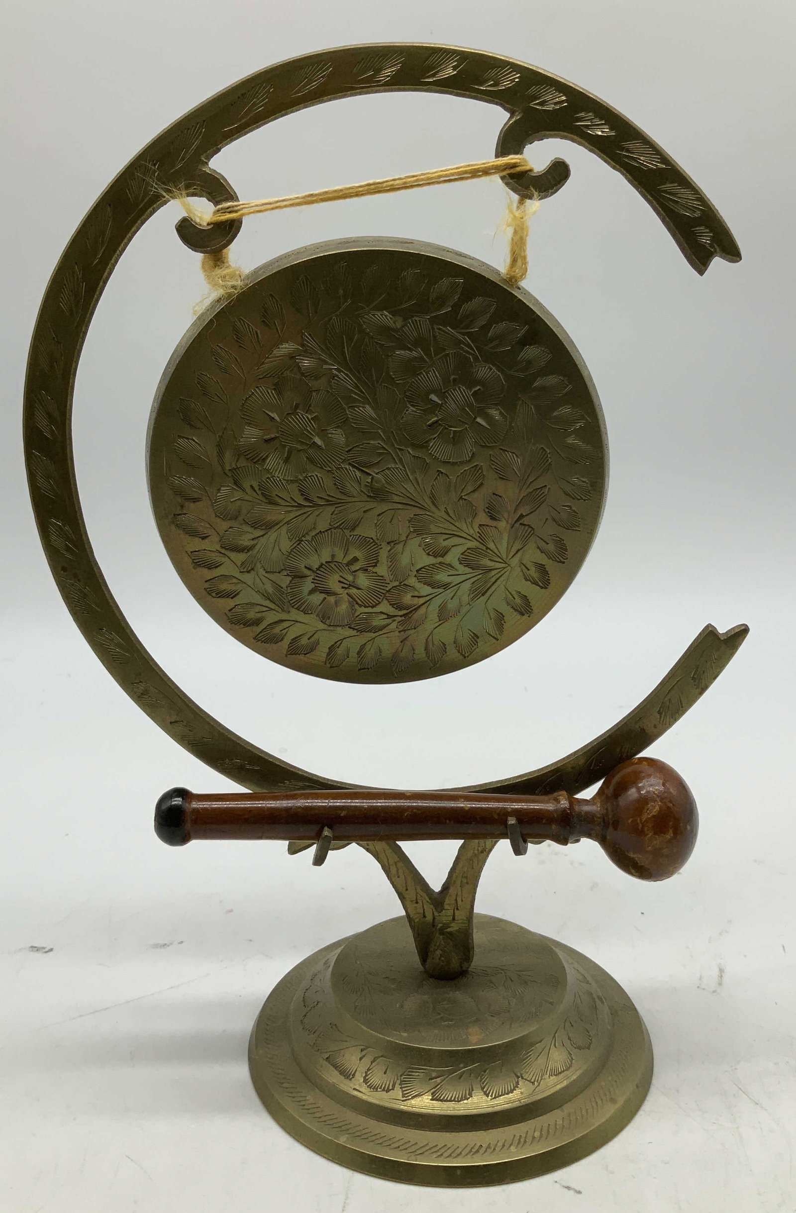 Vtg Etched Floral Brass Table Gong INDIA: Vintage brass table gong features intricate etched floral motifs on face & stand. Comes with wooden mallet. Signed & marked on underside. Reads, INDIA. Rest of lettering is not legible. Surface wear c