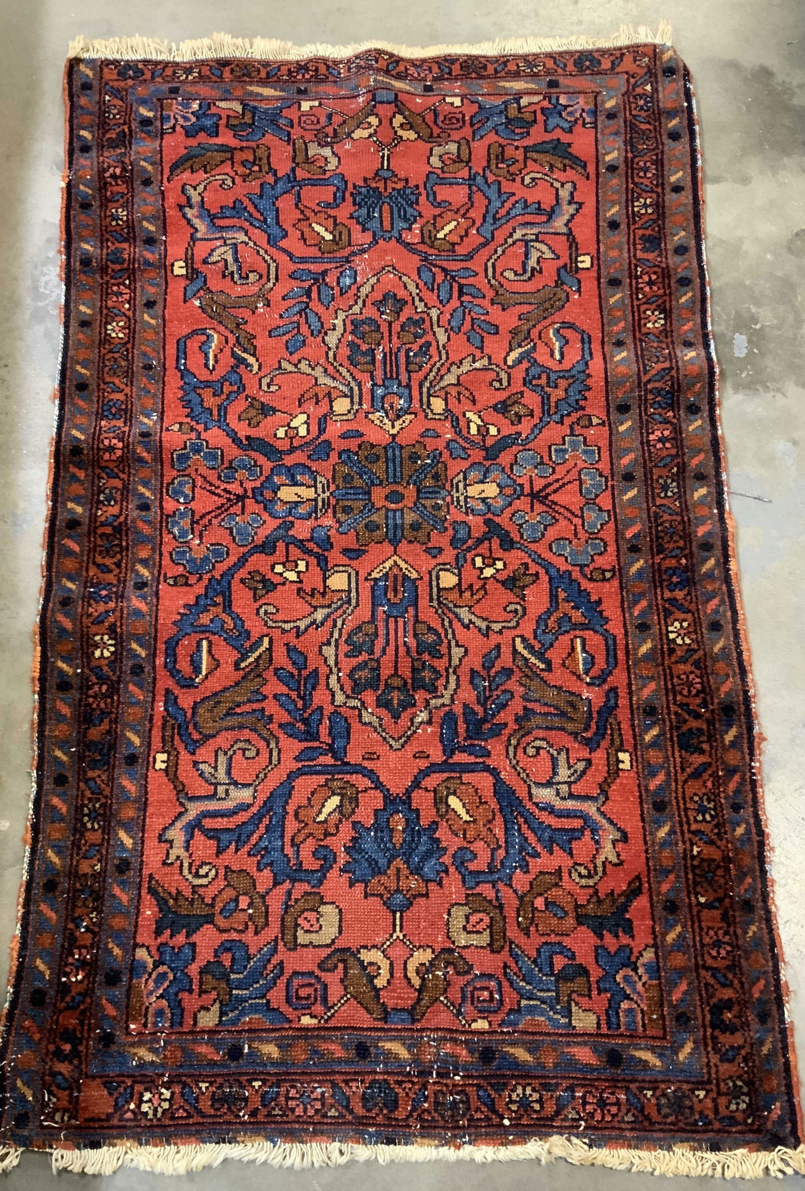 Antique Persian Style Lilihan Fringed Rug: Appears to be possible antique. Persian Lilihan rug features stylized floral & geometric patterns. Shades of red, blue, brown. Fringed ends. Surface wear consistent to age, use & exposure. Measurement