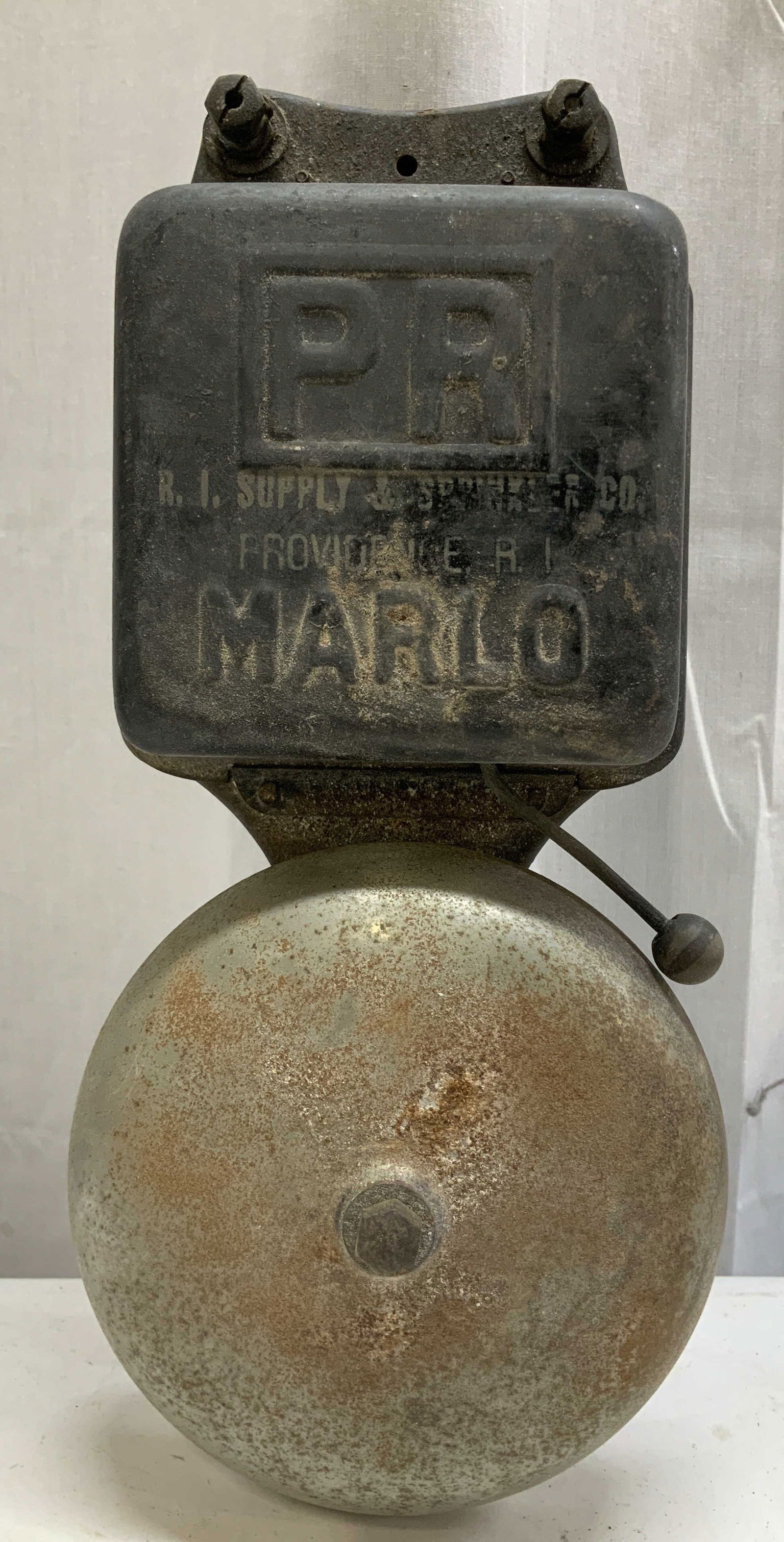 Antq RI Supply & Sprinker Co Marlo Fire Alarm Bell: Antq fire alarm bell. R.I. Supply & Sprinkler Co. PR Marlo alarm bell is black & metal toned. Piece has weight. Signed & marked. Reads, PR I. Supply & Sprinkler Co., Providence, RI MARLO. Surface wear