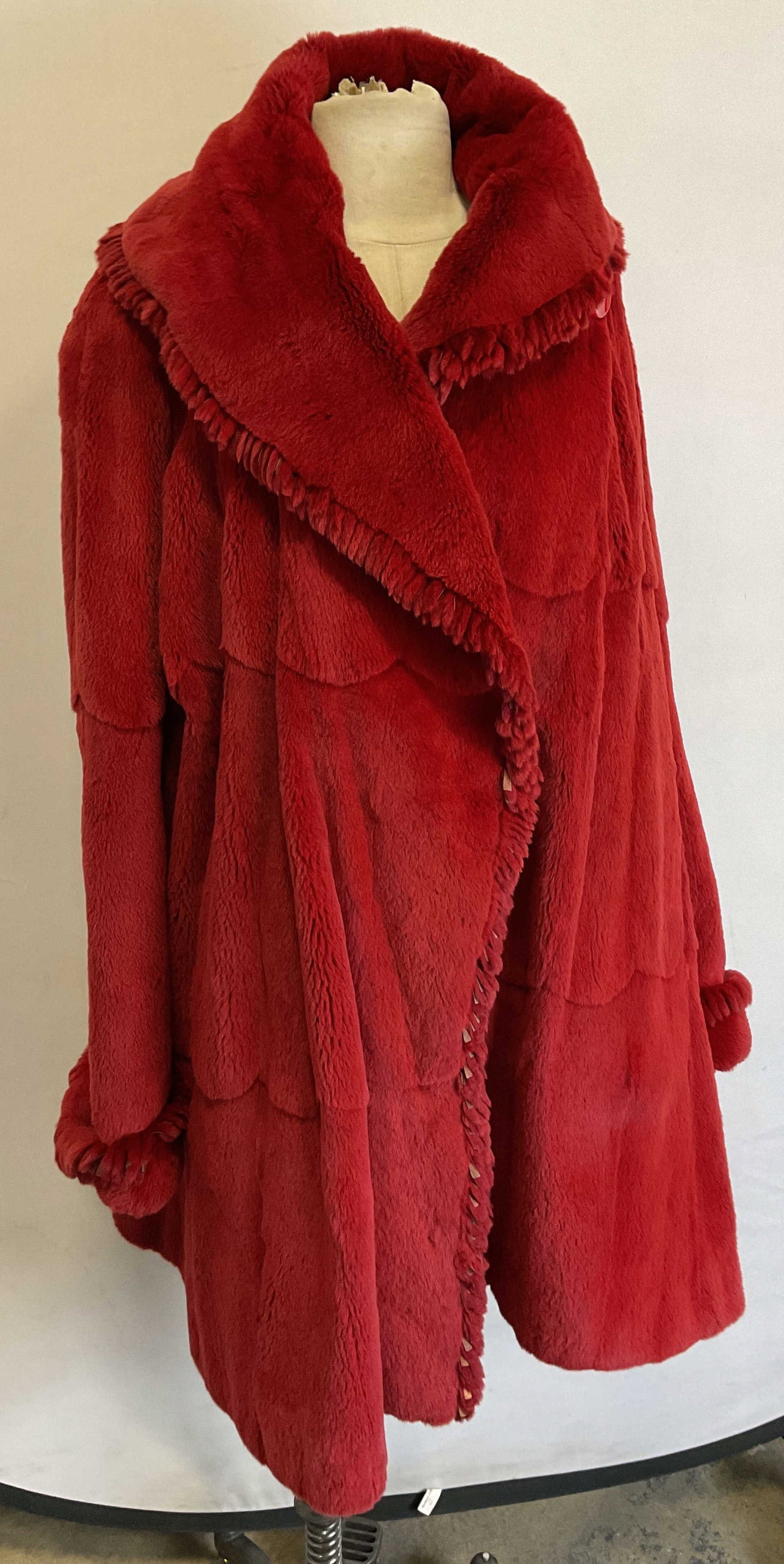 Vintage Red Sheared Fur Swing Coat: Vintage red sheared fur swing coat. Sheared fur material. Size XL. Custom embroidery on inside reading Shelia. Collared. Accented red button. Fringed collar and cuffs. Scalloped back. Wear consistent