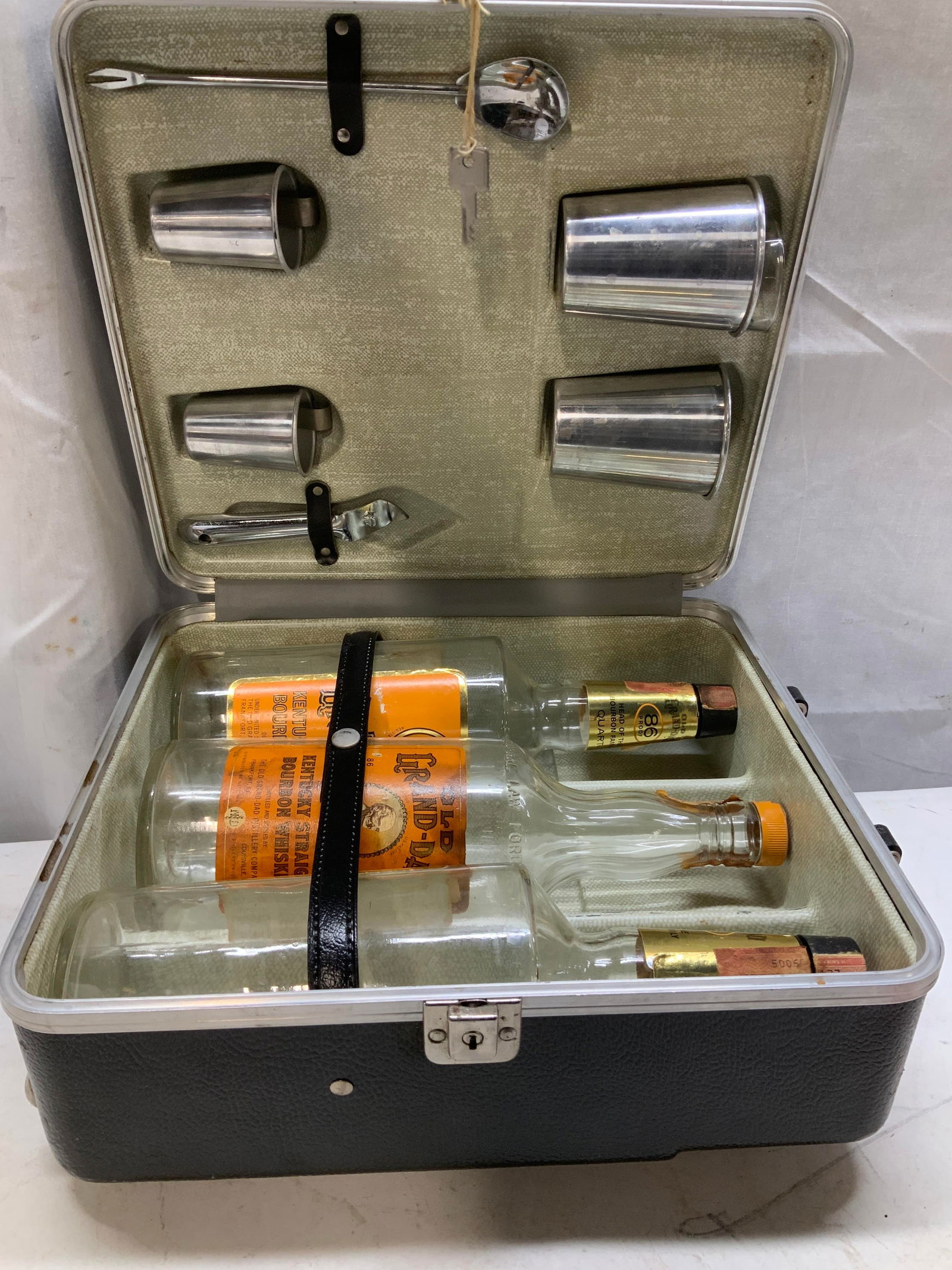 Lt11 Vtg Portable Travel Bar Case & Access. JAPAN: Lot includes, metal bottle opener, 4 bar beaker, one is my limit shot glass, bar spoon, 3 old grand-dad Kentucky straight bourbon whiskey empty bottles & portable travel bar case. Sold as is. Surface
