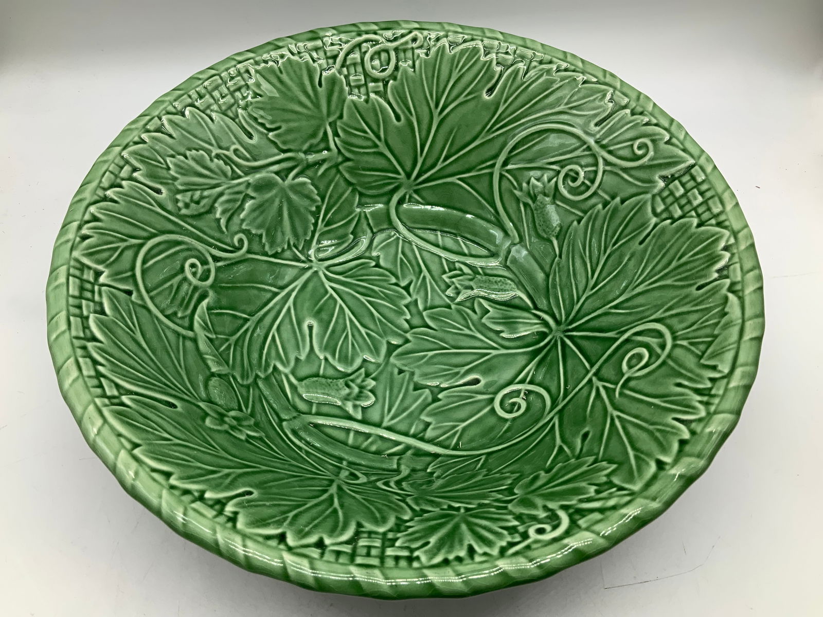 Bordallo Pinheiro Majolica Serving Bowl PORTUGAL: Bordallo Pinheiro green majolica large serving bowl, featuring an embossed design of leaves & vines on the interior. Basketweave pattern on the exterior. Signed & marked on underside. Reads, BORDALLO