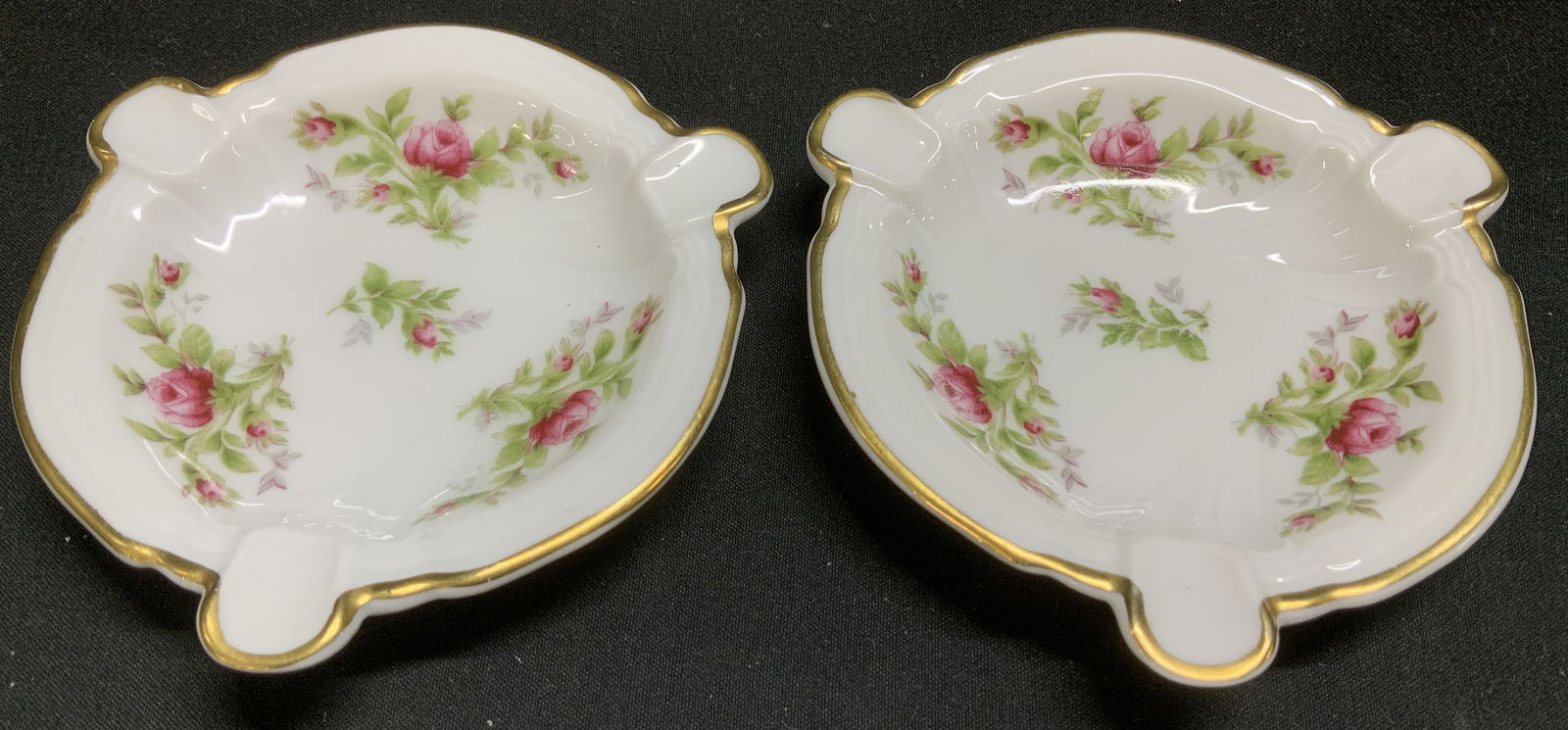 Lot 2 Vtg Rosenthal Floral Porc Ashtrays GERMANY: Lot includes, 2 vintage Rosenthal porcelain ashtrays featuring a pink rose pattern with gilt trim. Glossy finish. Signed & marked on underside. Reads, ROSENTHAL GERMANY. 2984 38. Surface wear consiste