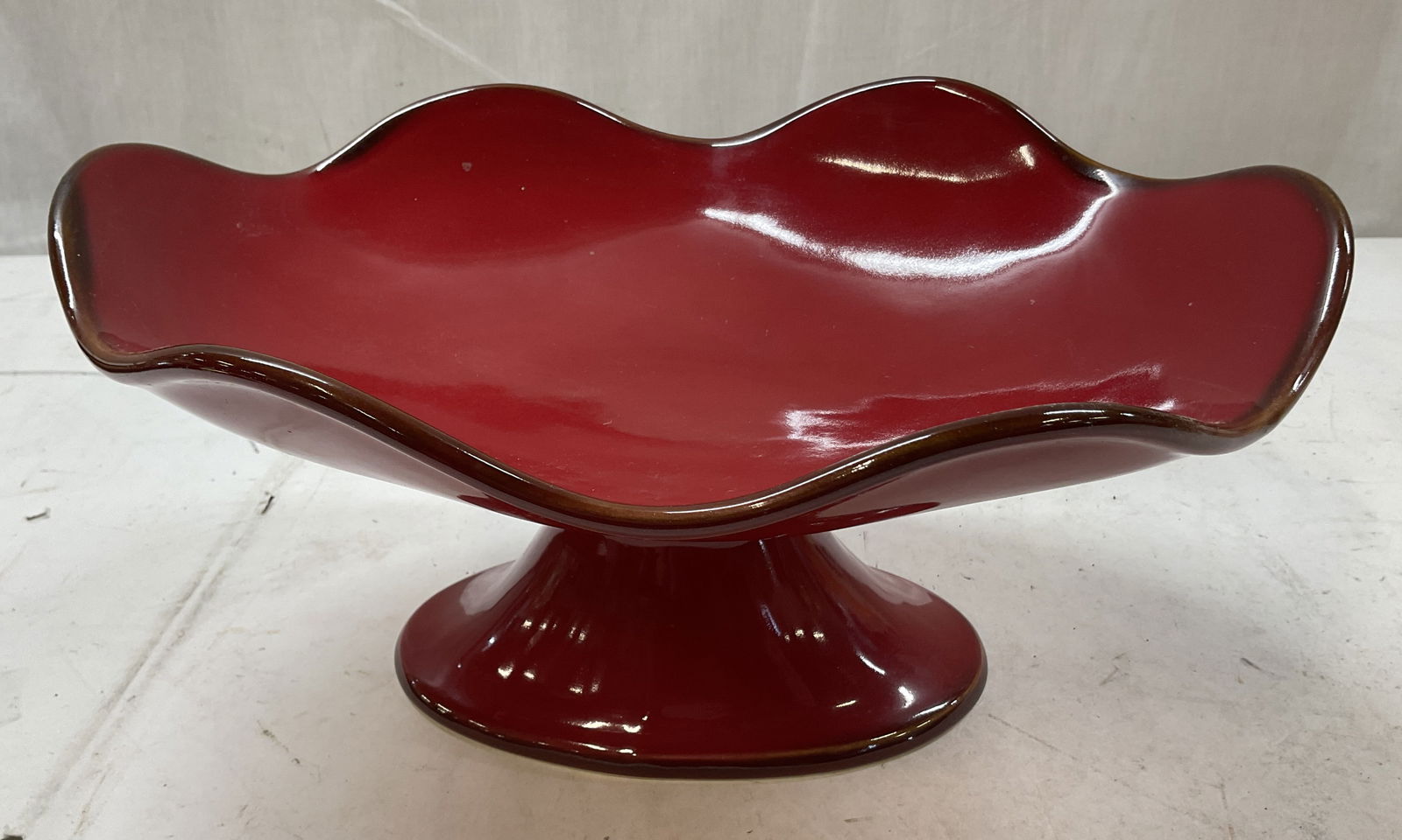 Southern Living At Home Pedestal Bowl Portugal: Southern Living At Home red cinnabar stoneware footed pedestal serving bowl. Made in Portugal. Signed and marked on underside, reads as follows Southern Living At Home Made In Portugal. Oval pedestal