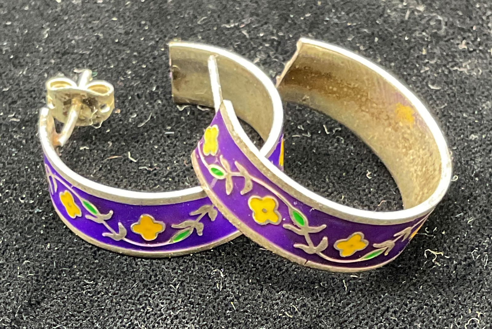 Sterling Silver Enamel Flower Earrings, Mexico: Vintage sterling silver hoop earrings with enameled floral design in purple and yellow. Marked sterling. Made in Mexico. Measure approx 7/8 inches wide. Total weight 5.9 grams. Some scratching. Jewelr