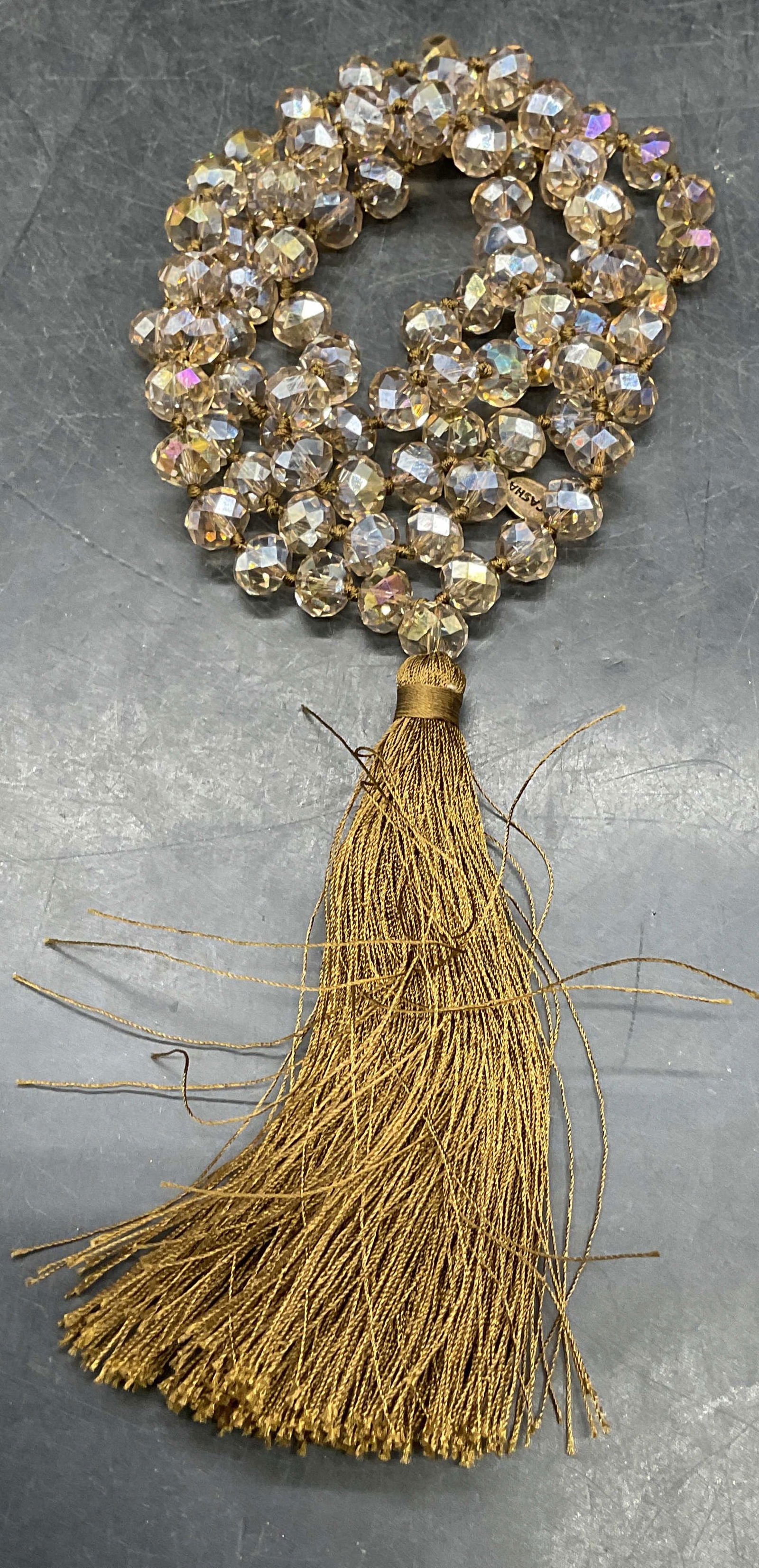 Zacasha Tan Crystal Beaded Tassel Necklace: Signed Zacasha tan crystal beaded necklace with tassel pendant. Drop length approx 18 inches. Some scratching. Jewelry, estate jewelry, costume jewelry, cocktail jewelry, fashion jewelry, accessories,