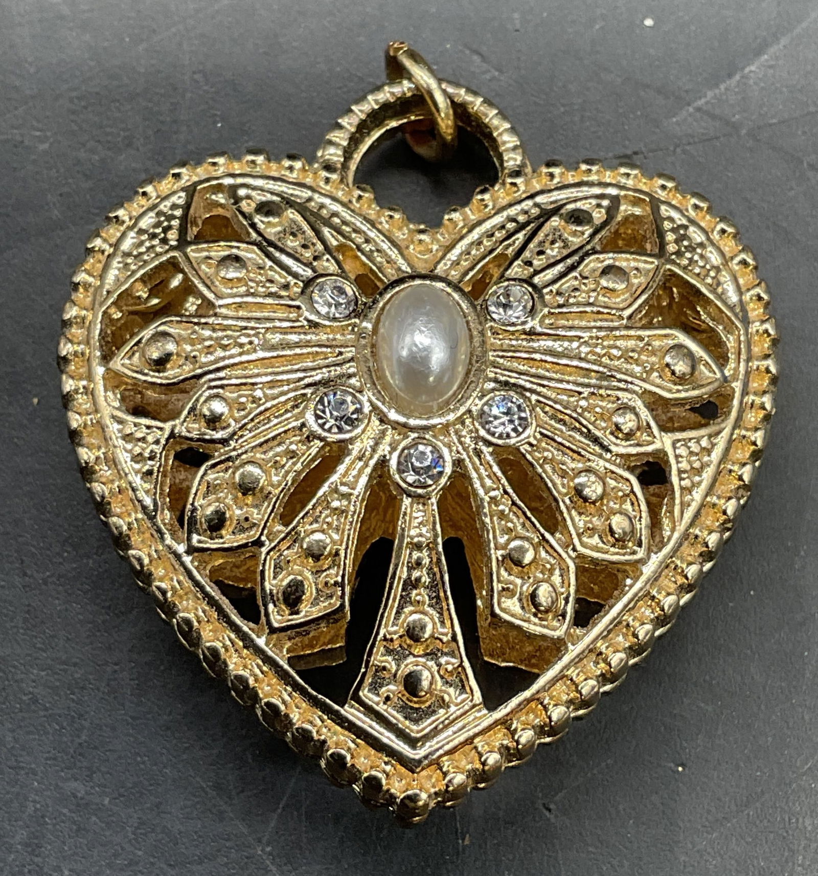 Gold Tone Faux Pearl Crystal Heart Pendant: Gold tone pierced heart pendant with crystal and faux pearl decoration. Measures approx 1.25 x 1.25 inches. Some scratching. Jewelry, estate jewelry, costume jewelry, cocktail jewelry, fashion jewelry