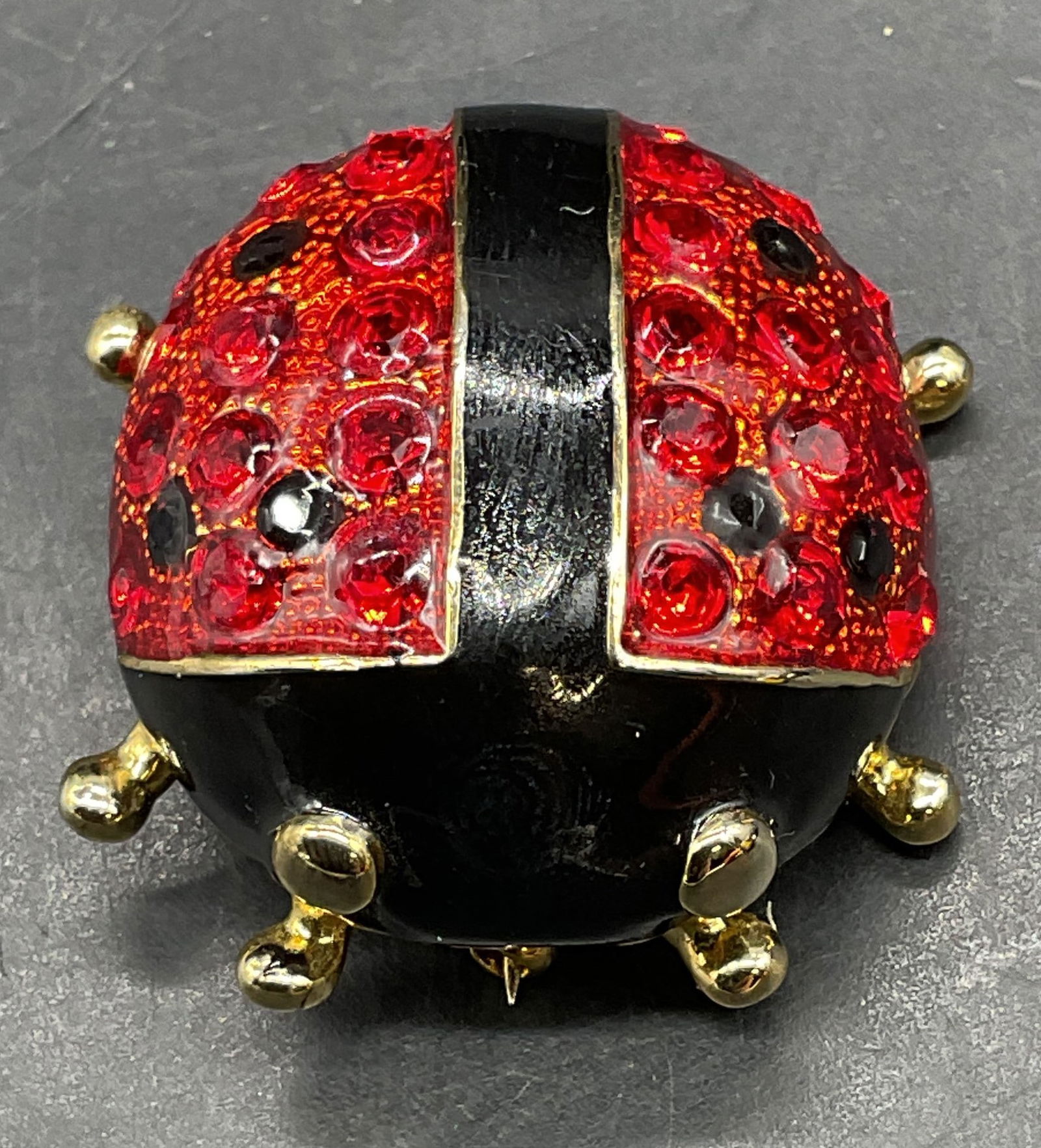 Gold Tone Enamel Crystal Ladybug Brooch: Gold tone red and black enamel ladybug brooch with crystal decoration. Measures approx 1.5 x 1.25 inches. One leg needs replacement. Some scratching. Jewelry, estate jewelry, costume jewelry, cocktail