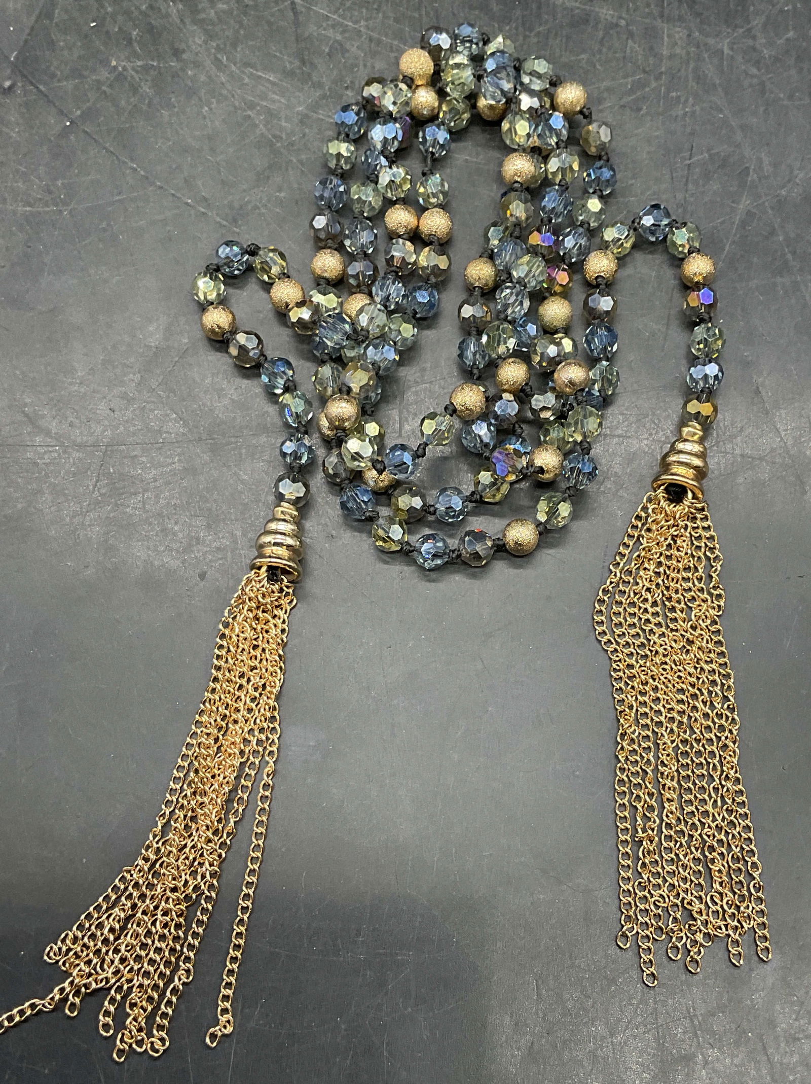Gold Tone Blue Crystal Beaded Lariat Necklace: Gold tone and blue crystal beaded lariat necklace with tassels. Drop length approx 19.5 inches. Some scratching. Jewelry, estate jewelry, costume jewelry, cocktail jewelry, fashion jewelry, accessorie