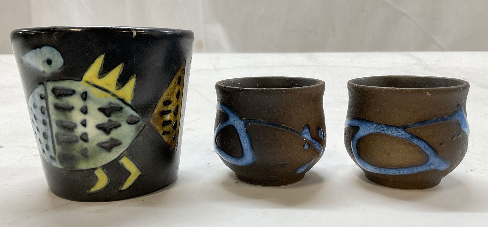 Lot 3 Vintage Ceramic Decorative Vessels: Lot of 3 vintage ceramic decorative vessels. Two are short and round shaped with a hand painted blue abstract design, raised surface. The other is tall and round shaped with a hand painted fish motif,