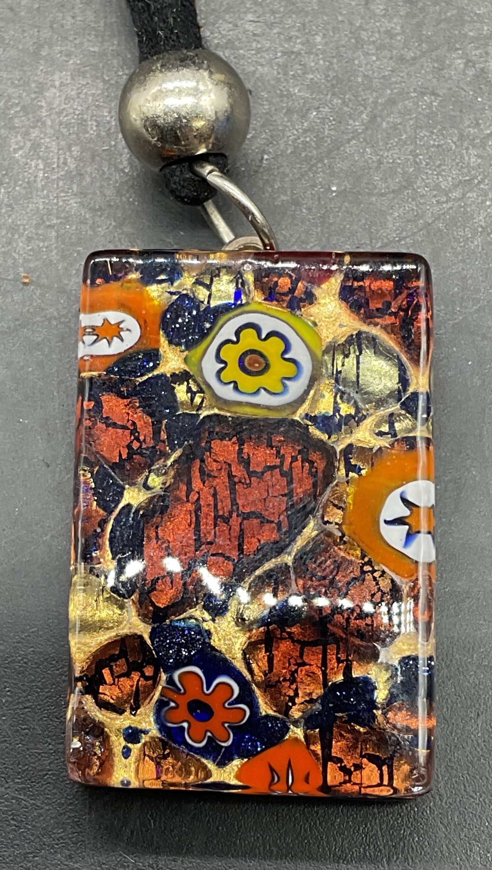 MURANO Art Glass Pendant Necklace, Italy: Signed MURANO millefiori art glass pendant necklace its black cord. Made in Italy. Drop length approx 9.5 inches. Pendant approx 1.25 x .75 inches. Jewelry, estate jewelry, costume jewelry, cocktail j