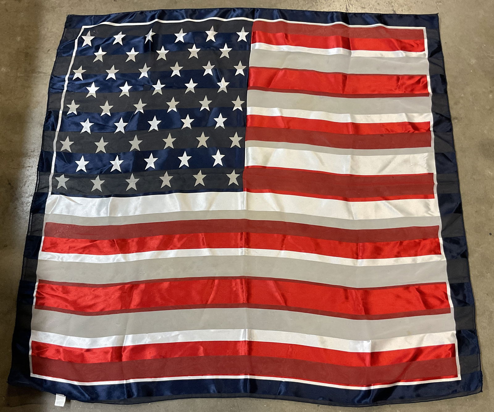 Vintage American Flag Sheer Silk Scarf: Vintage American Flag sheer silk scarf. Silk feel. Sheer accents. American flag design in red, white, and blue. Measures approx 38 x 39.5 inches. Wear to surface. Blemishes observed. Property of opera