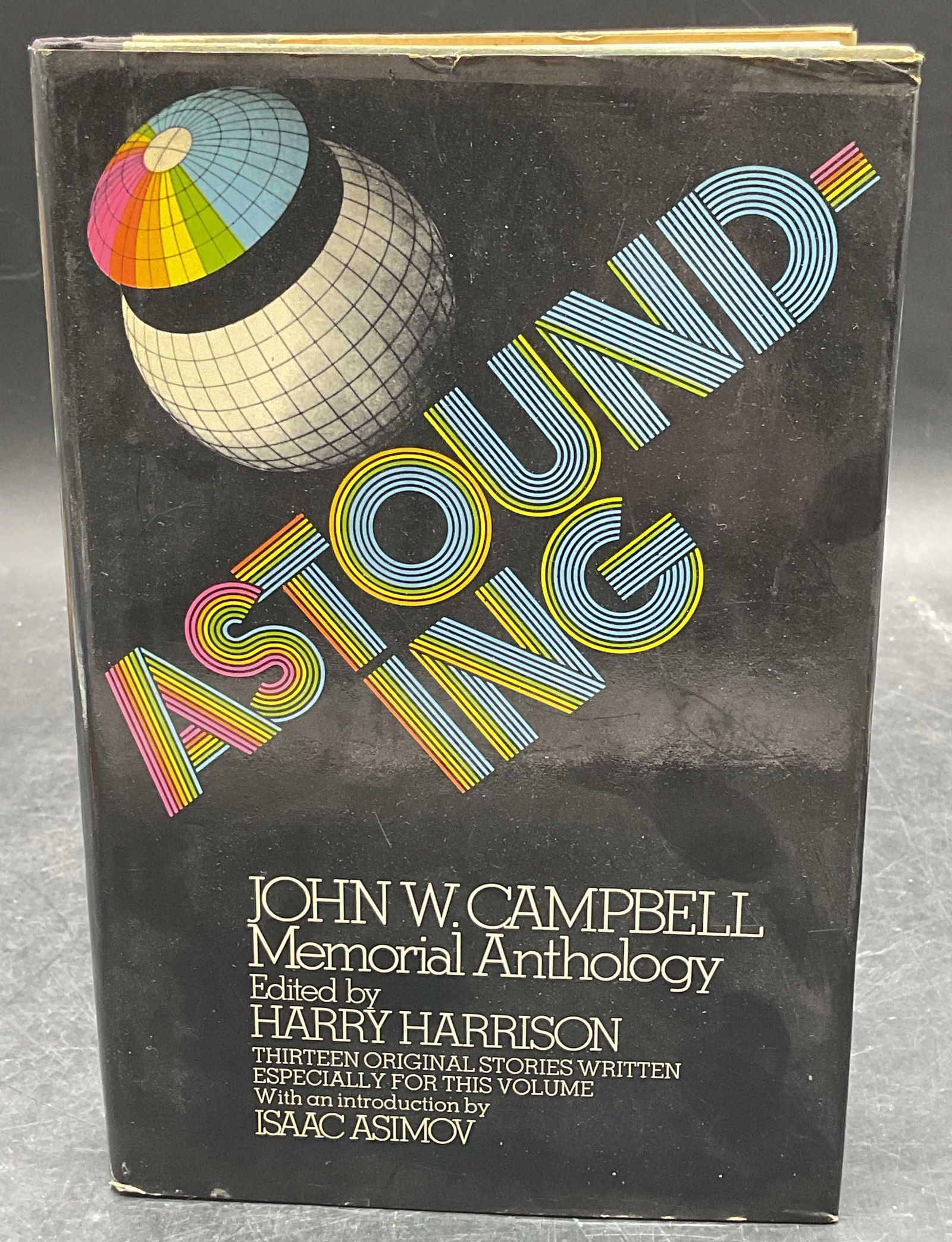 1973 Astounding Campbell Asimov 1st Edition: Hardcover first edition copy of Astounding John W Campbell Memorial edited by Harry Harrison with introduction by Isaac Asimov. Random House, 1973. Measures approx 8.5 x 5.75 inches. Some wear to cove