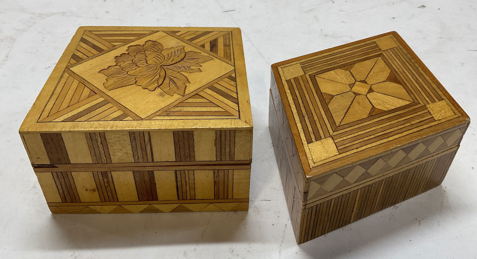 Lot 2 Vintage Hand Crafted Wooden Trinket Box: Lot of 2 vintage hand crafted wooden lidded trinket boxes. Square and diamond shaped. Inlaid geometric and floral motifs. Ribbed pattern. Largest measures approx 4.5 x 4.5 x 2.5 inches. Surface wear c