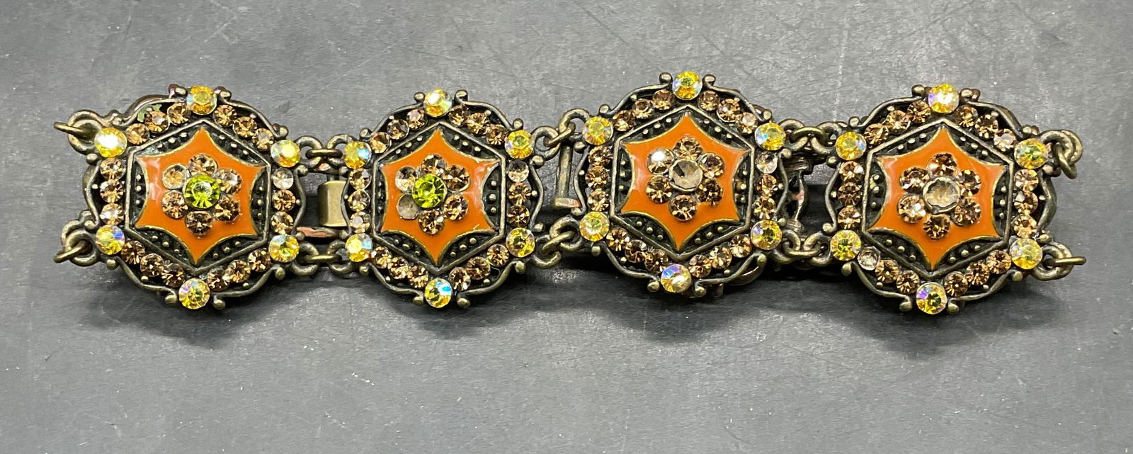 Joan Rivers Orange Enamel Crystal Bracelet: Signed Joan Rivers orange enamel and crystal decorated panel bracelet. Measures approx 7.5 inches long. Some scratching. Some crystals need replacement. Jewelry, estate jewelry, costume jewelry,