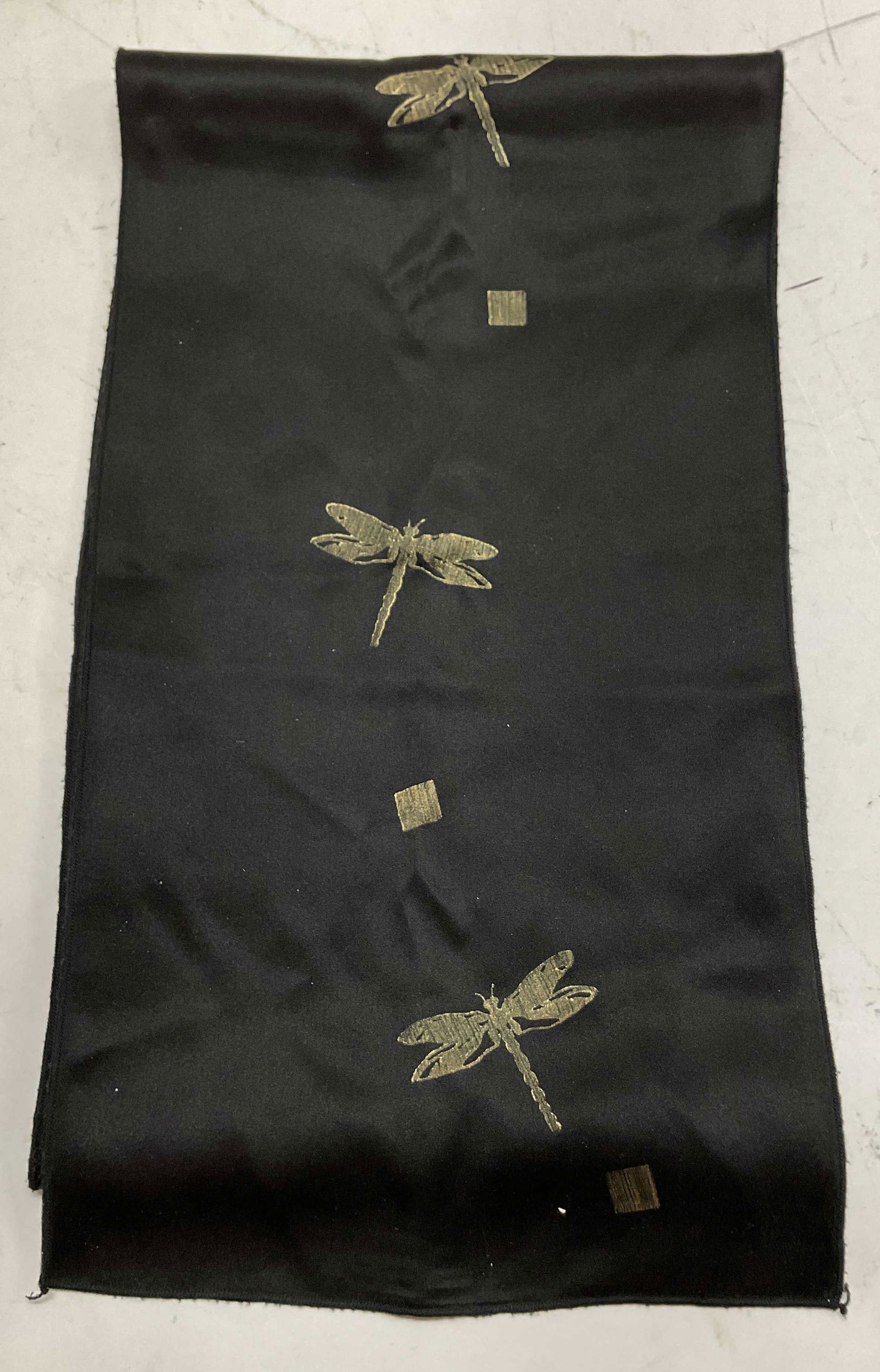 Vintage Black Dragonfly Silk Scarf: Vintage black dragonfly silk scarf. Silk material. Black background with gold toned dragonfly pattern. On reverse side is a gold toned background with leaf pattern in black and green. Measures