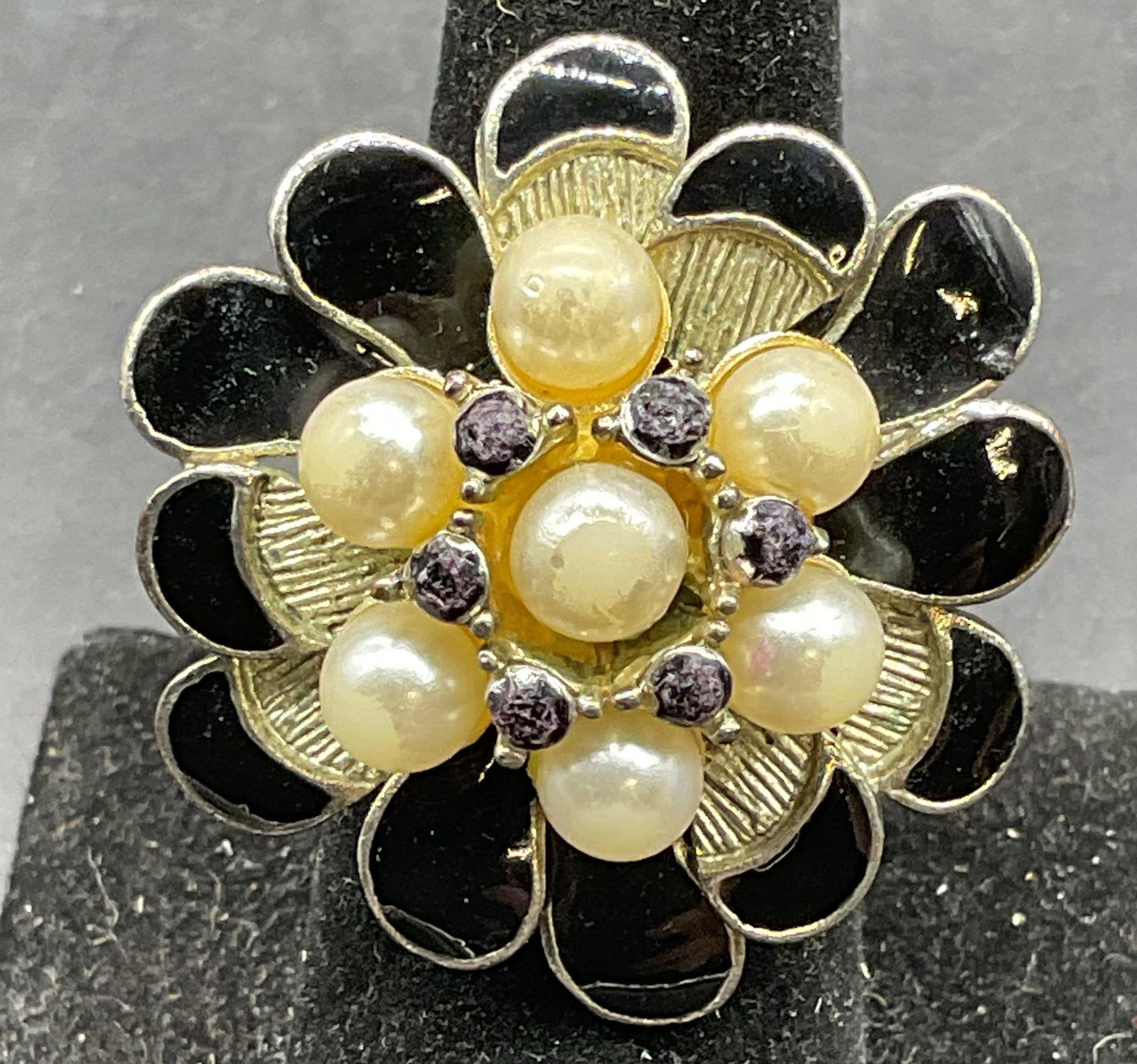 Vintage Enamel Faux Pearl Flower Cocktail Ring: Vintage silver tone adjustable band cocktail ring. Enamel and faux pearl flower setting. Setting measures approx. 1.25 inches wide. Some scratching. Jewelry, estate jewelry, costume jewelry,