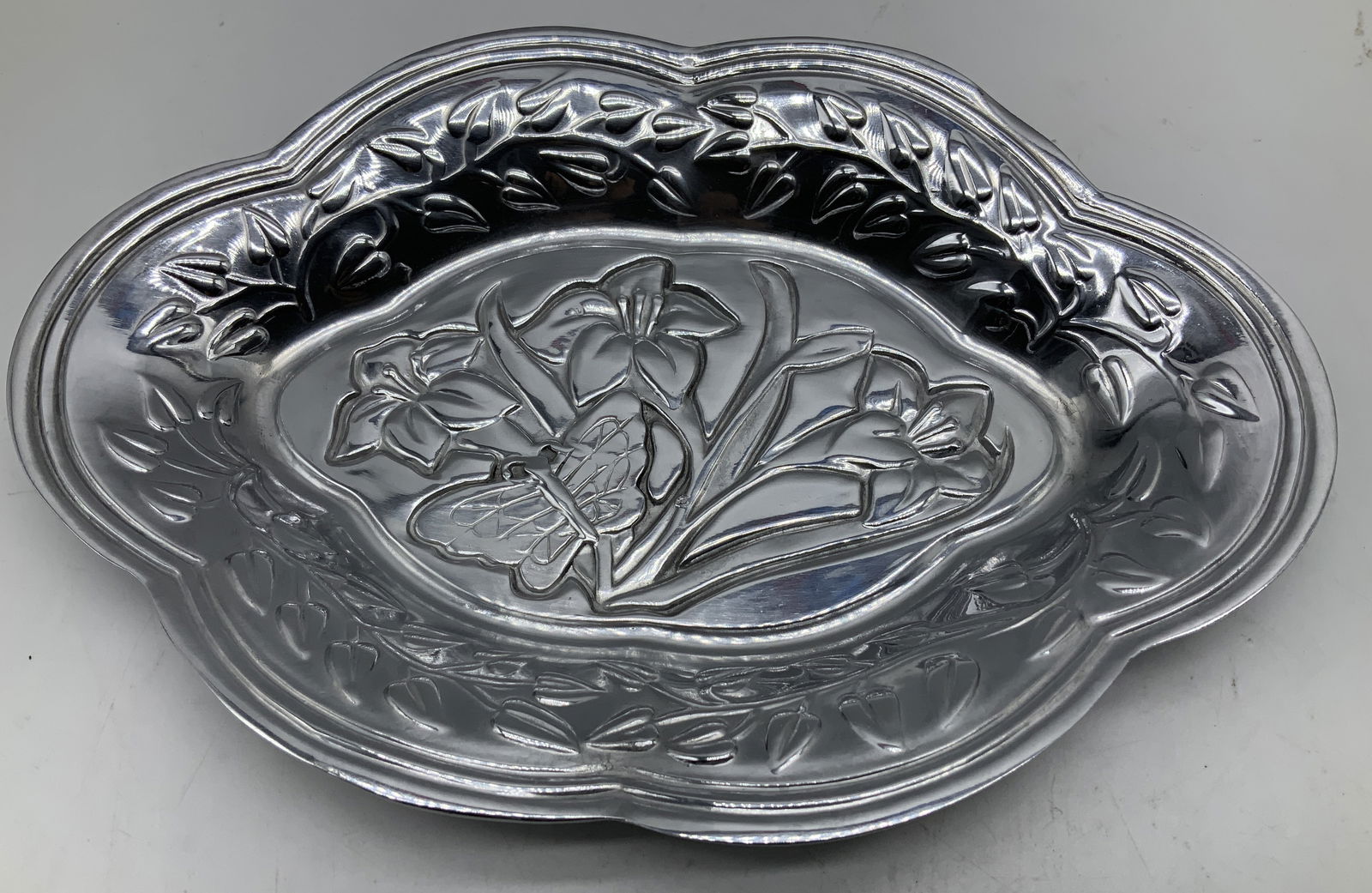 Lenox Butterfly Meadow Oval Metal Tray: Lenox Butterfly Meadow oval metal tray features an embossed floral & butterfly design. Silver toned. Signed & marked on underside. Reads, LENOX. BUTTERFLY MEADOW. Surface wear consistent to age, use &