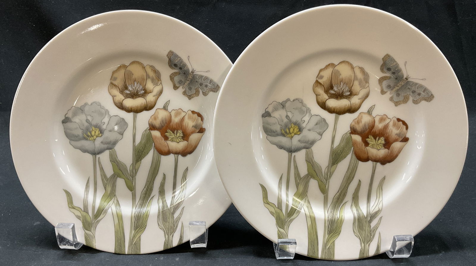 Pair Fitz & Floyd Pastel Poppy Plate Japan 1976: Pair of Fitz and Floyd Pastel Poppy porcelain plates. Signed and marked on underside, reads as follows Pastel Poppy Fitz And Floyd Inc 1976 FF 20 FF Japan. Features floral, leaf, and butterfly motifs.