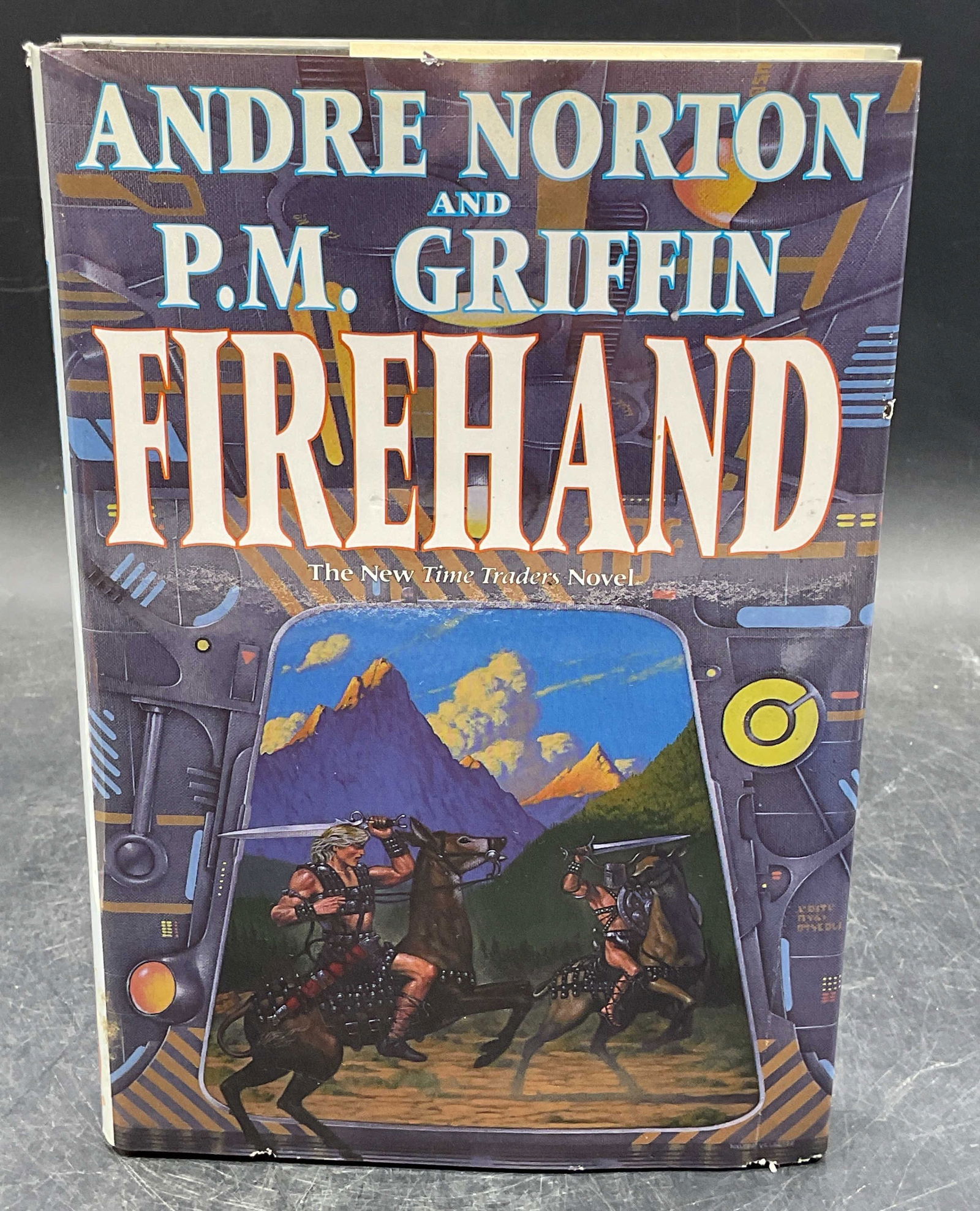 1994 Norton & Griffin Firehand 1st Edition: Hardcover first edition copy of Firehand by Andre Norton and P. M. Griffin. Tor, 1994. Measures approx 8.5 x 5.75 inches. Some wear to cover, pages, and binding consistent with exposure. Book, first e